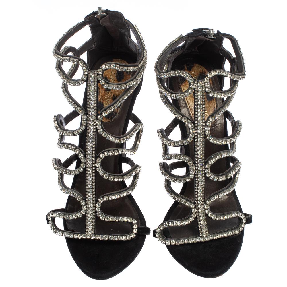 Complete a glamorous look with these Roberto Cavalli sandals! They are secured with crystal-embellished suede uppers and enhanced with cut-out details. The sandals are set atop leather insoles and 12 cm heels.

Includes: Original Dustbag
