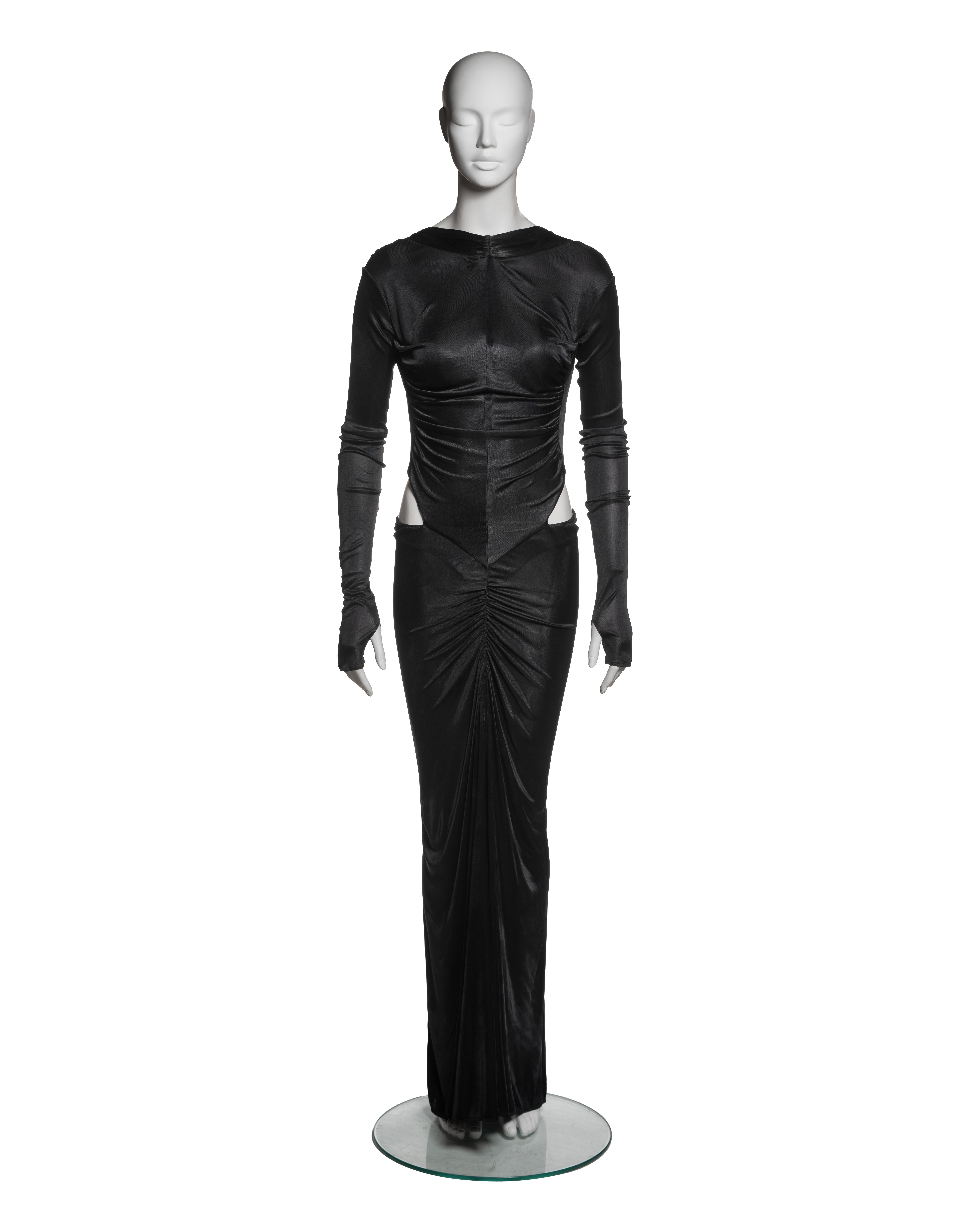 This Roberto Cavalli black viscose evening dress features a high neckline, long sleeves with thumb holes at cuffs, and a floor-length skirt with a subtle train. The bodice and skirt incorporate strategic ruching along the centre front, enhancing the