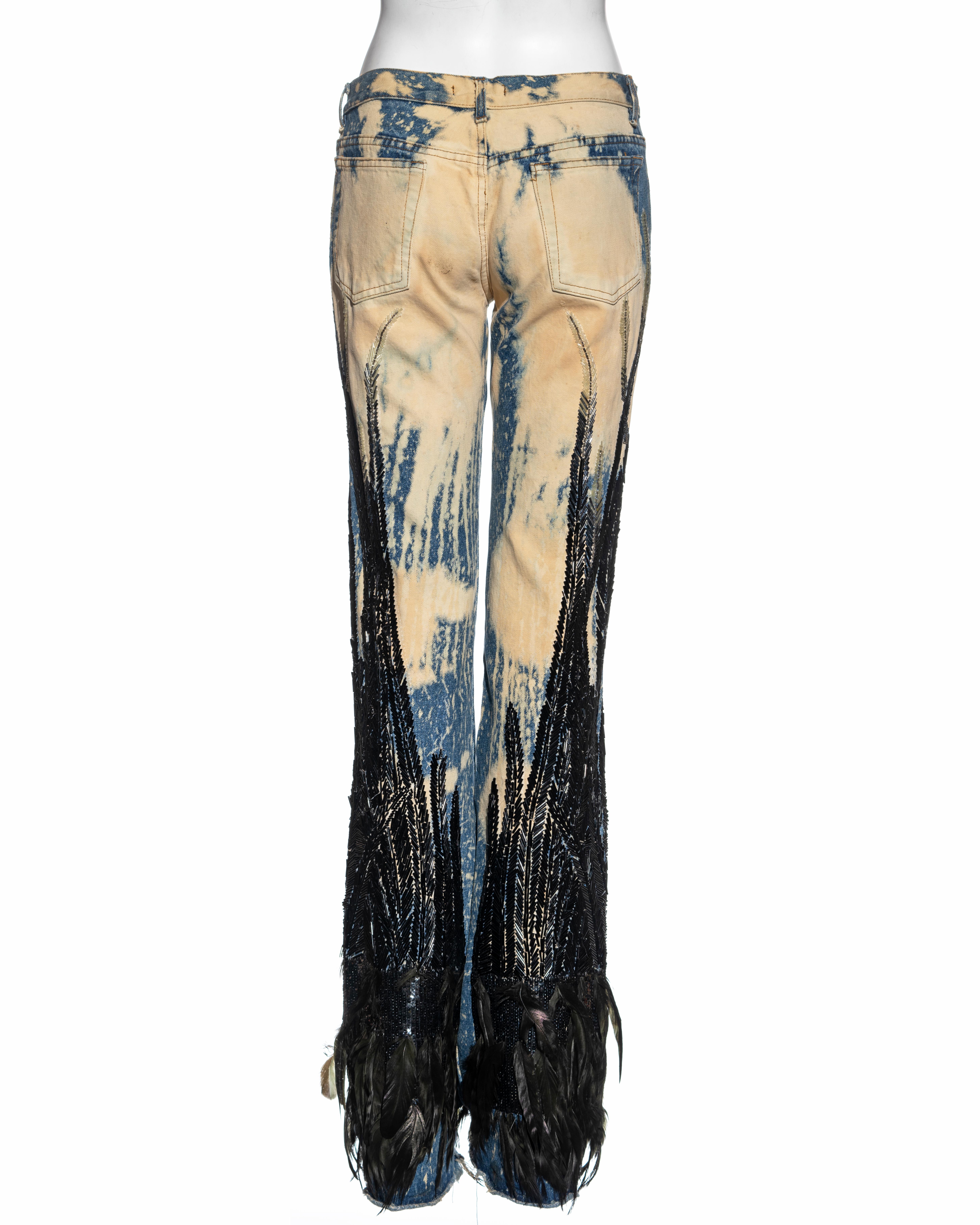 ▪ Roberto Cavalli runway jeans 
▪ Bleached denim 
▪ Black bugle beads and sequins
▪ Feather embellishments at the hem 
▪ Straight leg 
▪ Size Small
▪ Fall-Winter 2001
▪ 100% Cotton
▪ Made in Italy