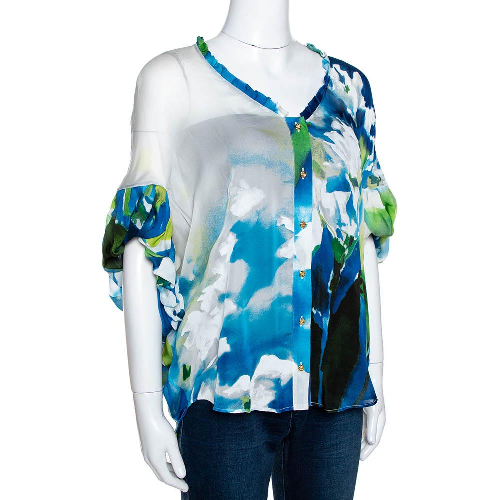 Stylish and fun, this Roberto Cavalli blouse is great for outings. It has been cut from pure silk and comes in a lovely shade of blue. It flaunts an interesting print throughout. It has gathered sleeves, a v-neck and button closure.

