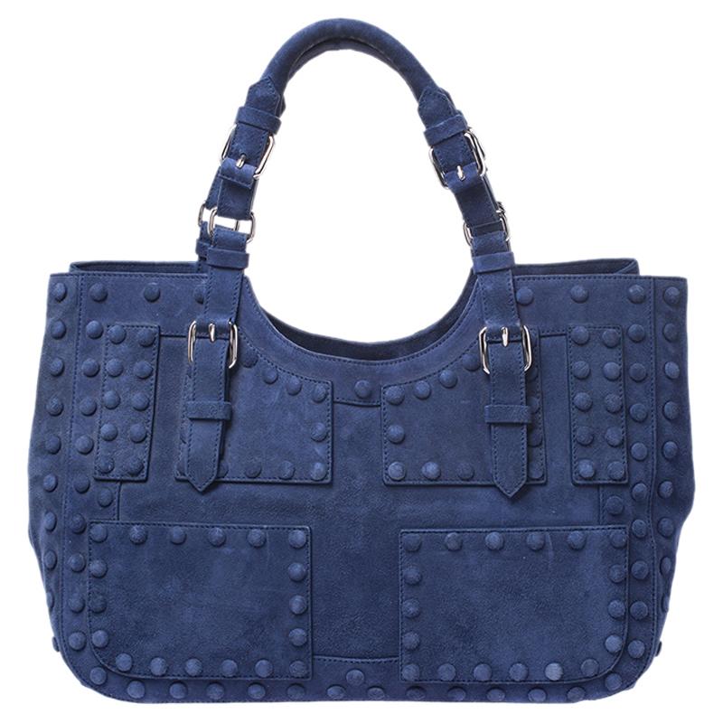 This Roberto Cavalli tote can accommodate all your daily essentials. Crafted from blue suede, it is accented with matching studs. It features buckled straps on the exterior and two top handles. The tote boasts of a spacious red leather-lined