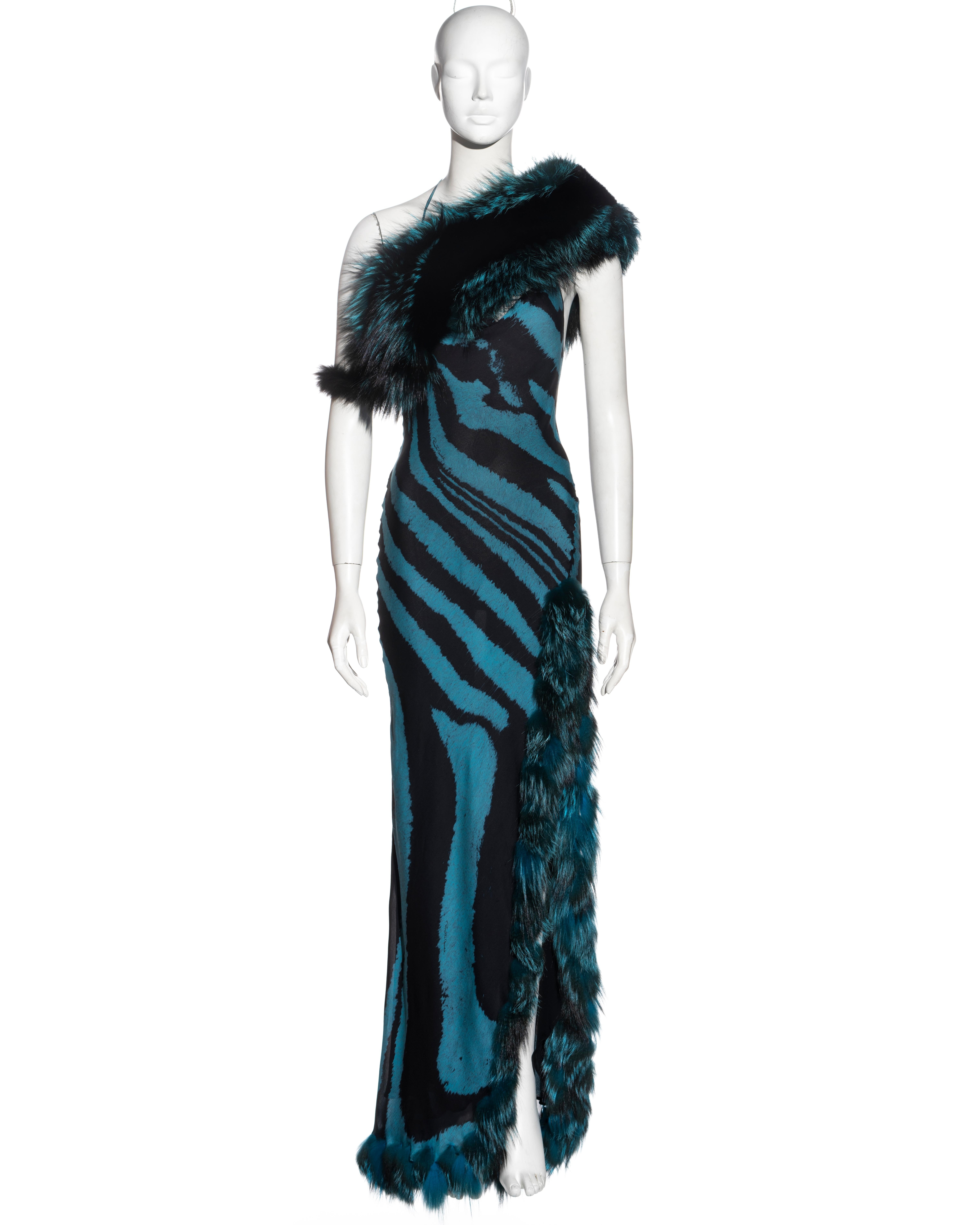 ▪ Important Roberto Cavalli evening dress
▪ Bias cut silk with blue and black tiger print
▪ Fox fur trim 
▪ High leg slit 
▪ Cowl neck 
▪ Halter-neck with string ties 
▪ Matching fox fur stole 
▪ Size Medium
▪ Fall-Winter 2000
▪ 100% Silk
▪ Made in