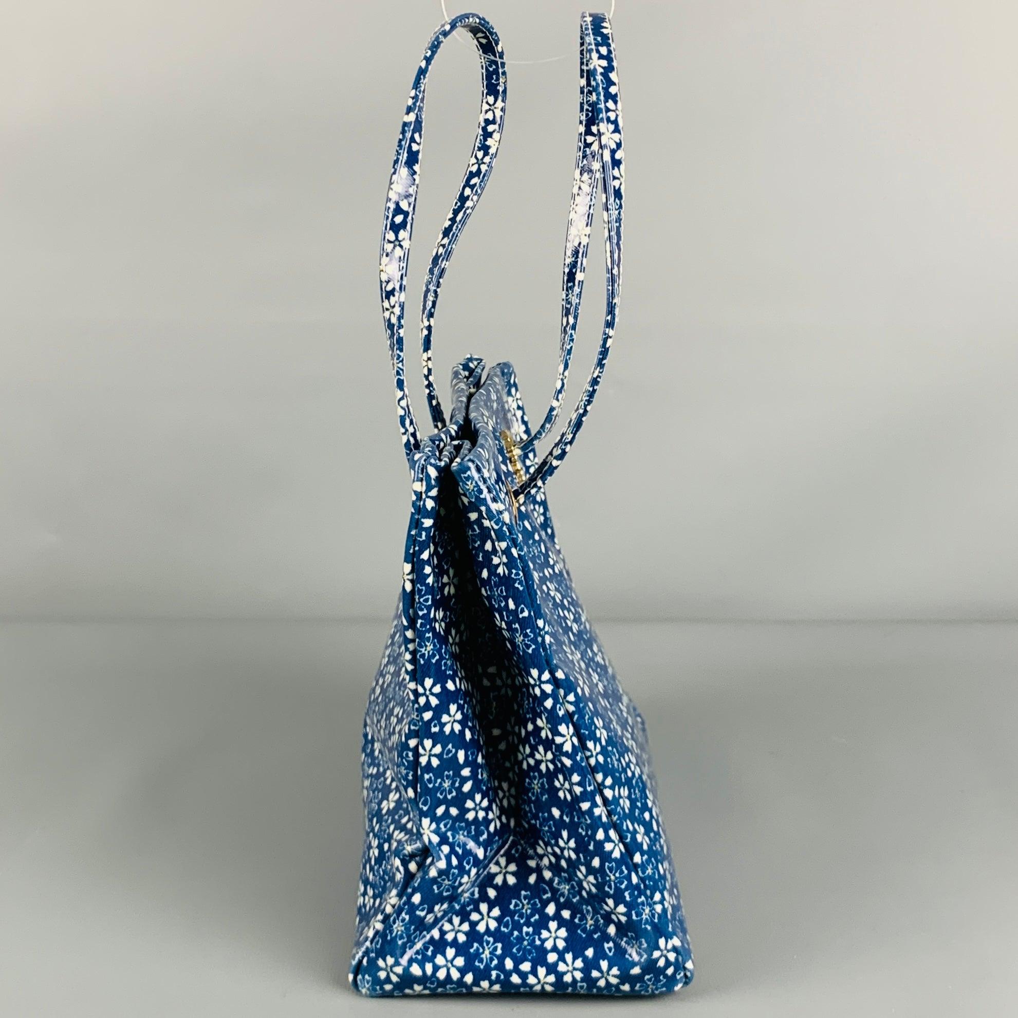 ROBERTO CAVALLI handbag in a blue and white coated canvas featuring mini tote style, floral pattern, brand monogram, and top handles. Made in Italy.Excellent Pre-Owned Condition. 

Measurements: 
  Length: 8.5 inches Width: 4.25 inches Height: 
7.5