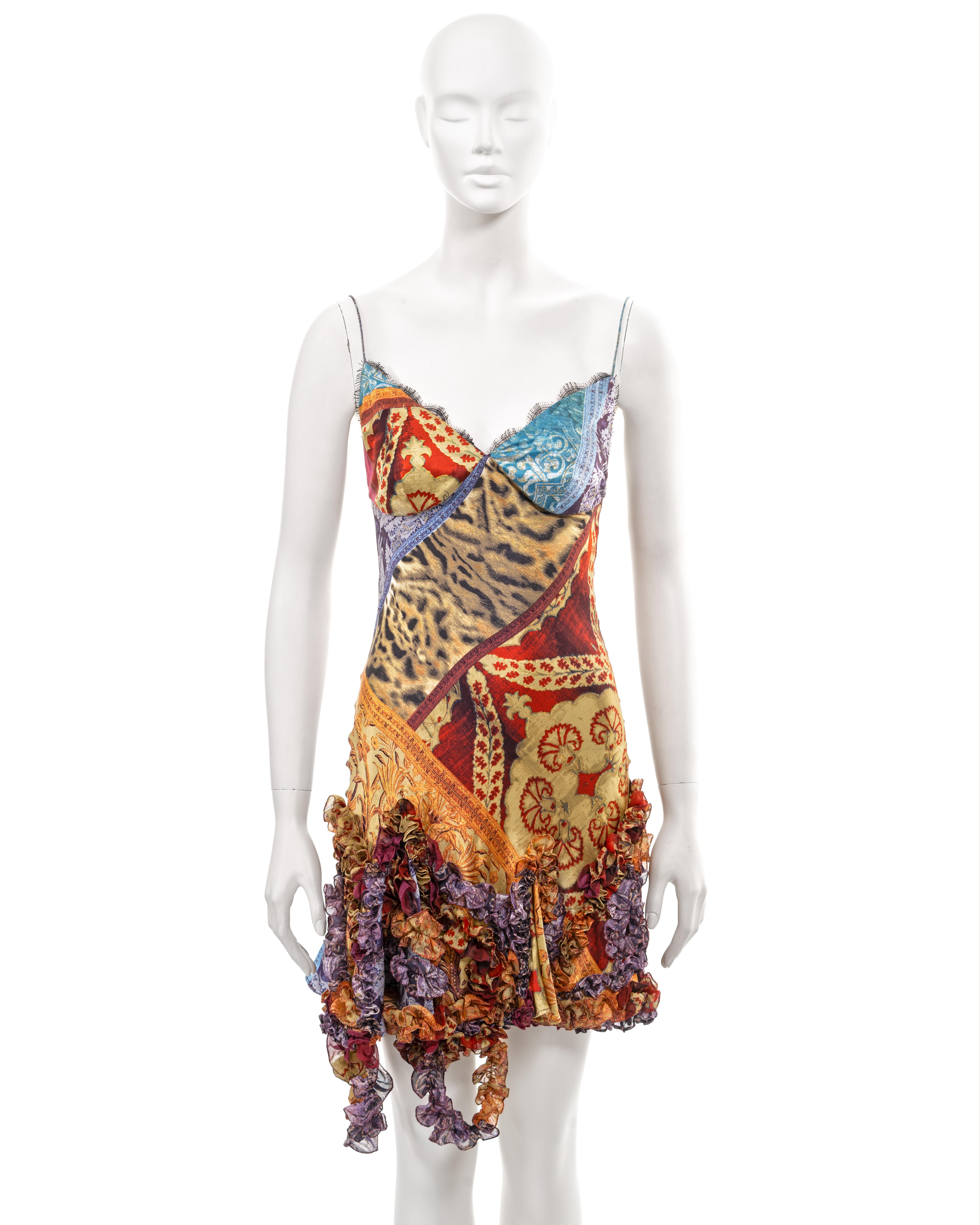 ▪ Roberto Cavalli evening slip dress
▪ Sold by One of a Kind Archive
▪ Fall-Winter 2004 
▪ Constructed from silk
▪ Patchwork motif of leopard and brocade prints in shades of orange, purple, red, blue and gold 
▪ Mini skirt with ruffled silk ribbon