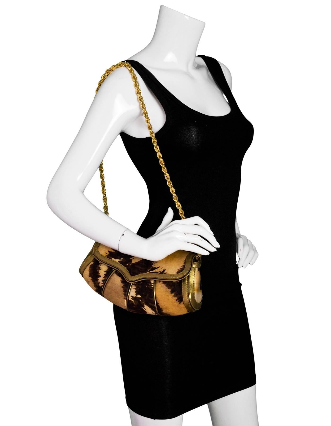 Roberto Cavalli Brown & Gold Satin Evening Clutch/Shoulder Bag

Made In: Italy
Color: Brown, gold
Hardware: Goldtone
Materials: Satin, leather
Lining: Beige textile
Closure/Opening: Flap top with snap closure
Exterior Pockets: None
Interior Pockets: