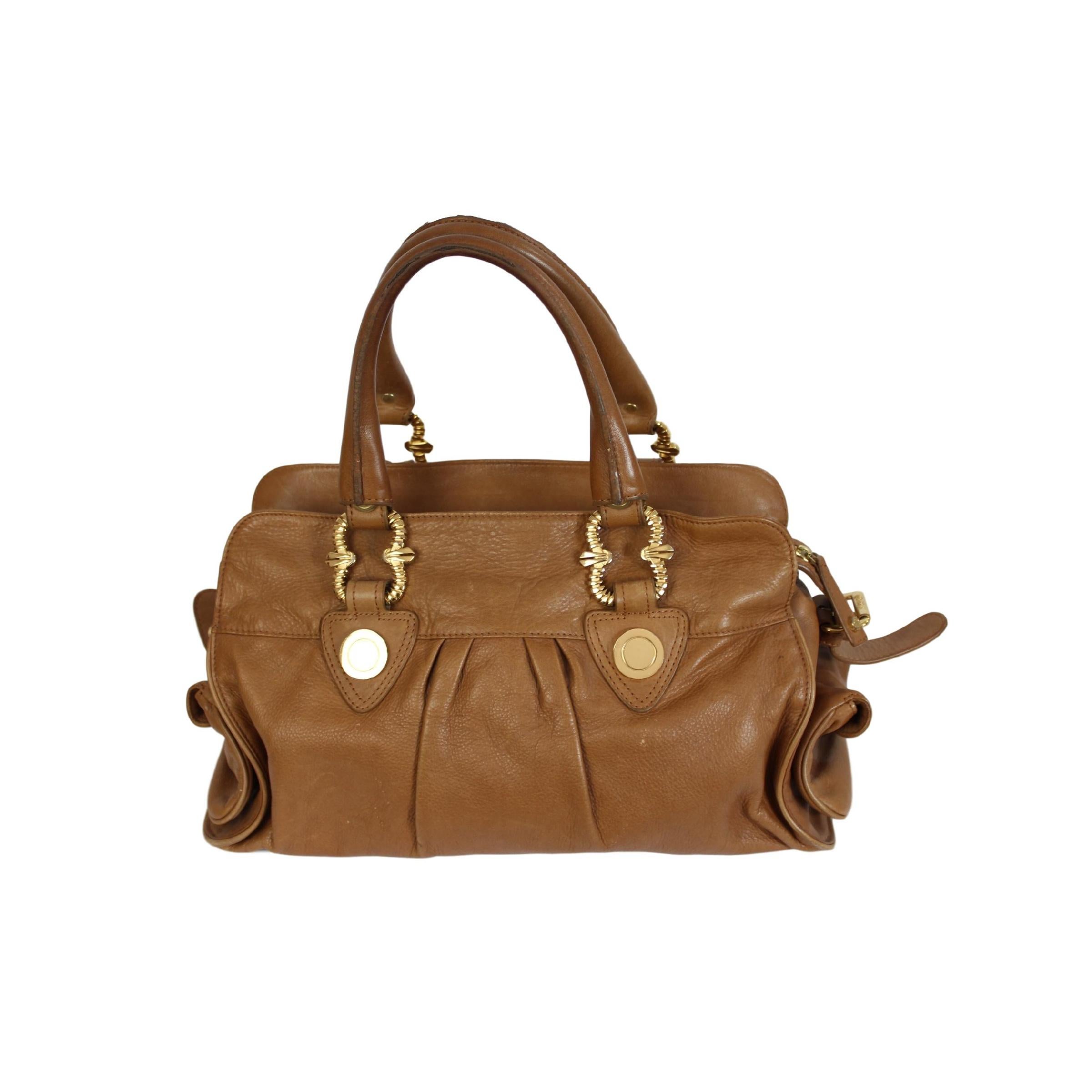 Vintage leather bag by the Italian designer Roberto Cavalli. The bag is in brown leather with pendants and special gold details. Made in Italy of the 2000s in good condition.

height: 23 cm
width: 40 cm