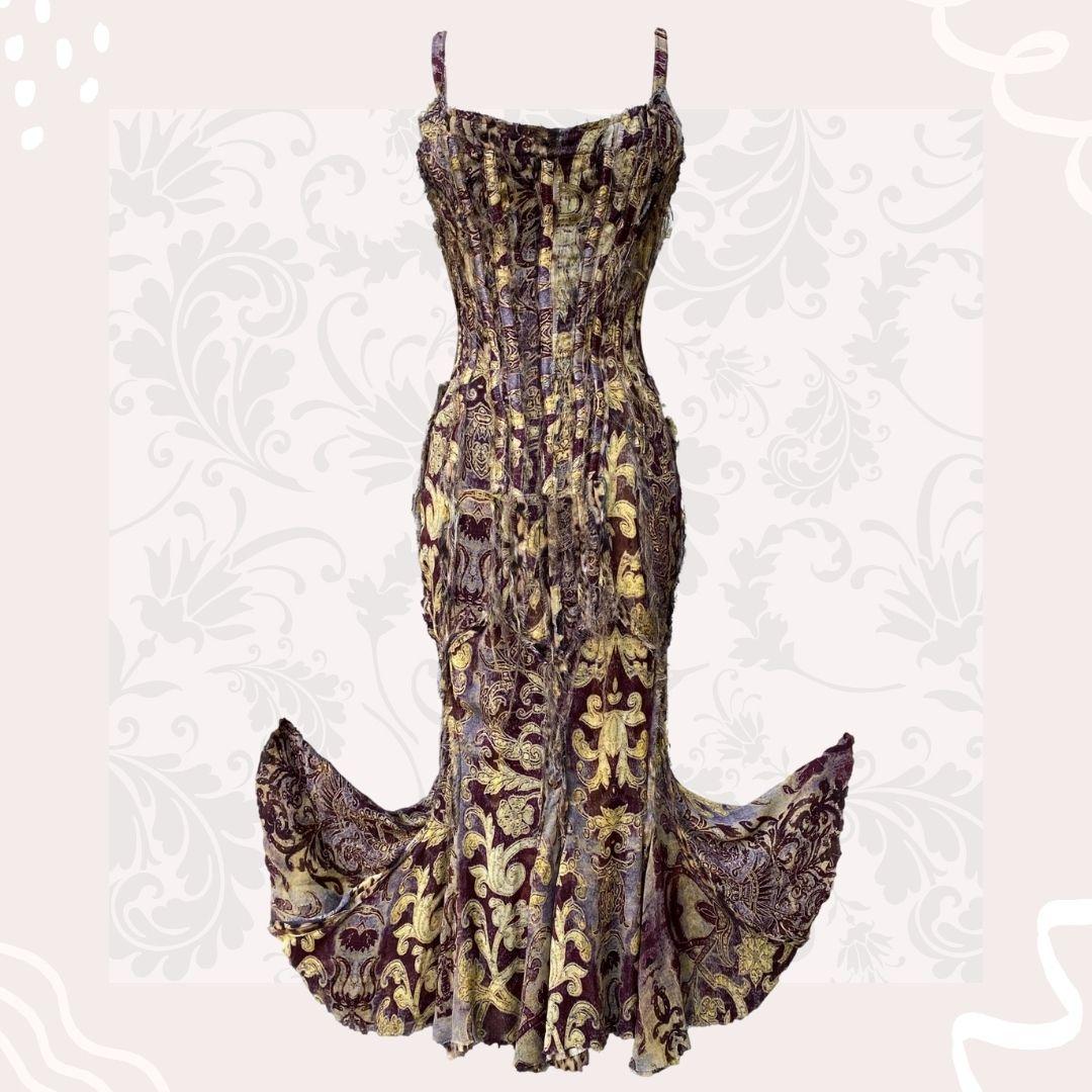 Roberto Cavalli - This gold and burgundy frayed dress has a certain je ne sais quoi about it. The sexy, rustic dress is made out of two layers of delicate silk fabric.  The outer layer of gold and burgundy print and the inner lining is Roberto