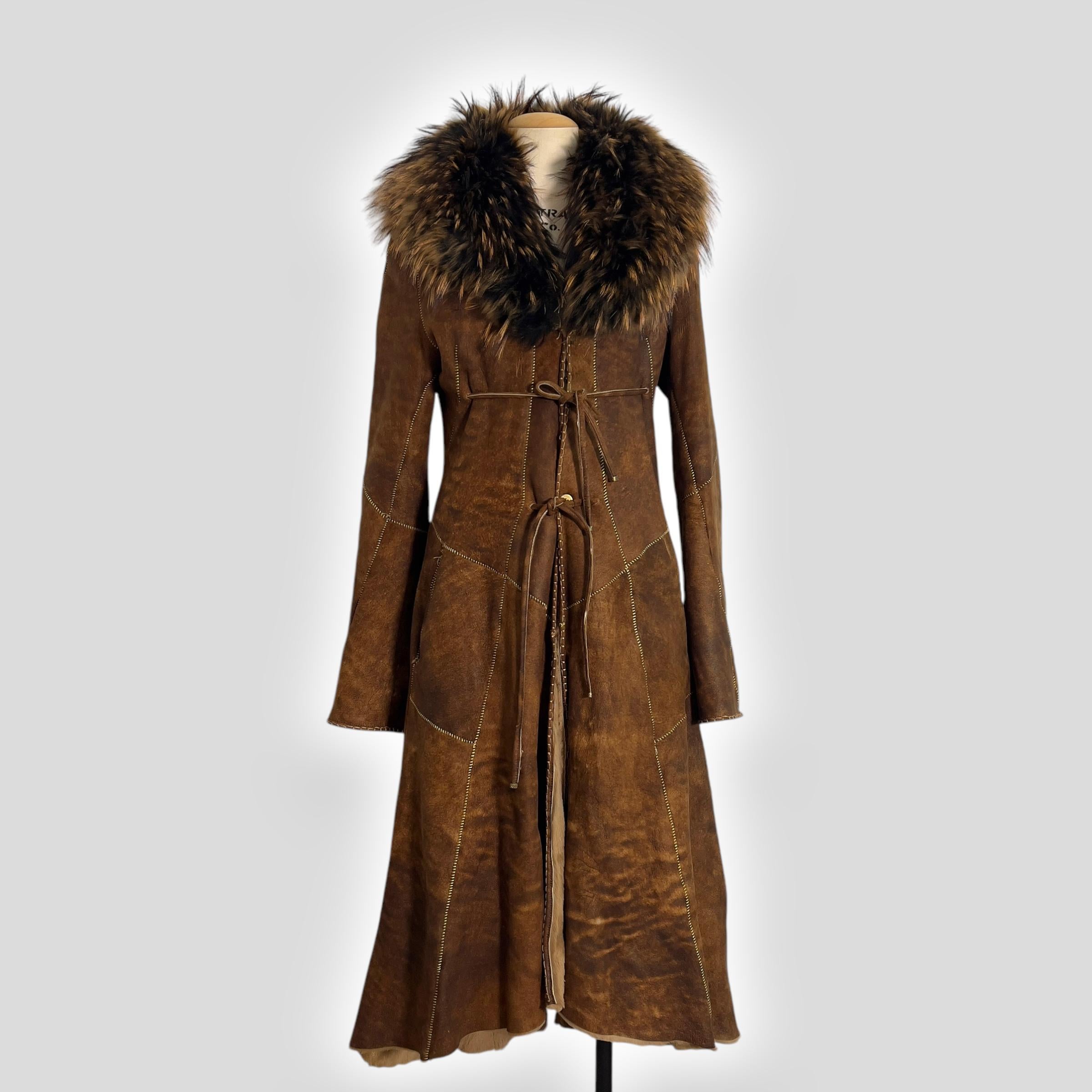 Roberto Cavalli Reversible Shearling Coat, Early 2000s

Piece Description: This exquisite early 2000s reversible shearling coat by Roberto Cavalli is a luxurious yet practical statement piece.
The coat features a fox fur shawl collar that adds a