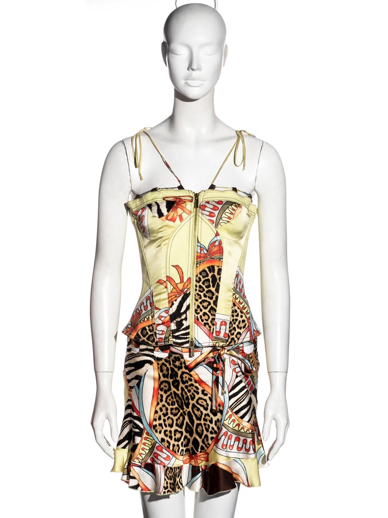 ▪ Roberto Cavalli 2-piece set
▪ Chartreuse silk with a leopard, zebra and floral montage print
▪ Corset with cotton panels and drawstring shoulder straps 
▪ Front-zipper 
▪ Back lace-up fastening 
▪ Mini skirt with flounced hem and drawstring