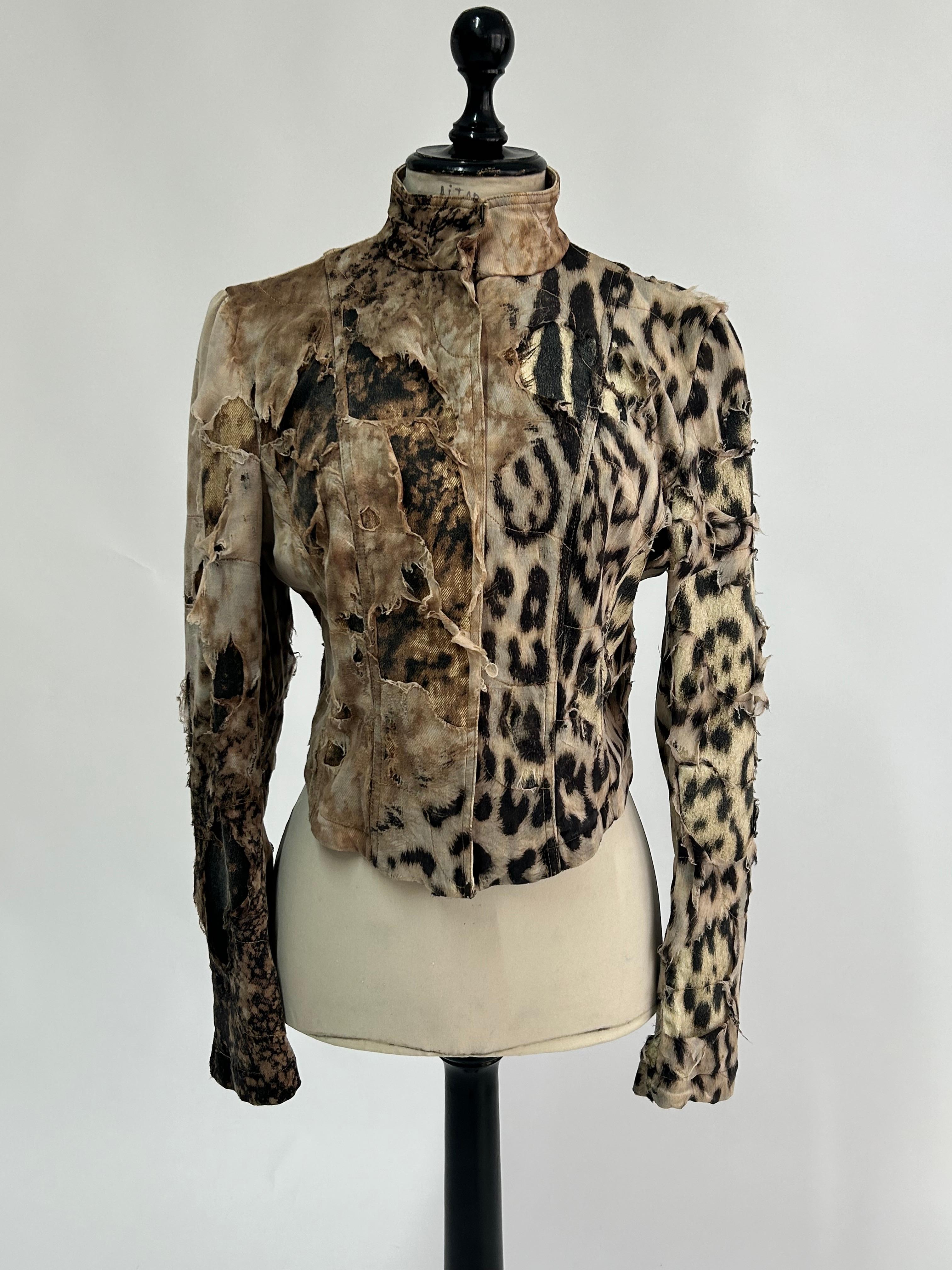 Very rare piece from the Fall 2001 collection.
This jacket beautifully layers fabric and print as it covers the cheetah print cotton base in exquisite, torn-up silk that is held in place by undulating stitching patterns, giving this piece its unique