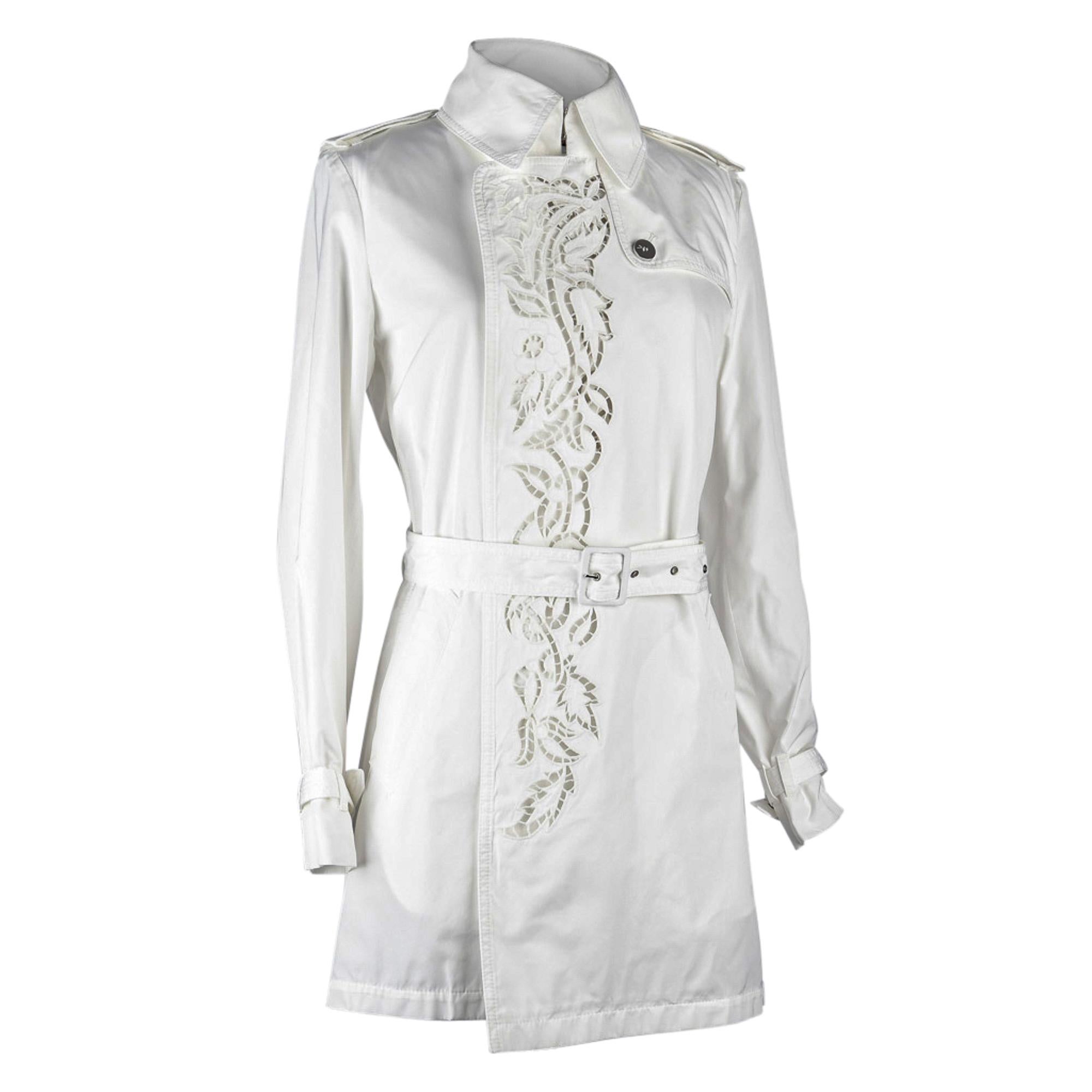 Guaranteed authentic Roberto Cavalli charming light winter white trench coat with silver buttoned epaulets. 
Beautiful laser cut lace effect detail down front of trench.
Classic collar, belt and straps at cuffs.
Back flap. 
Rear kick pleat.
NEW or
