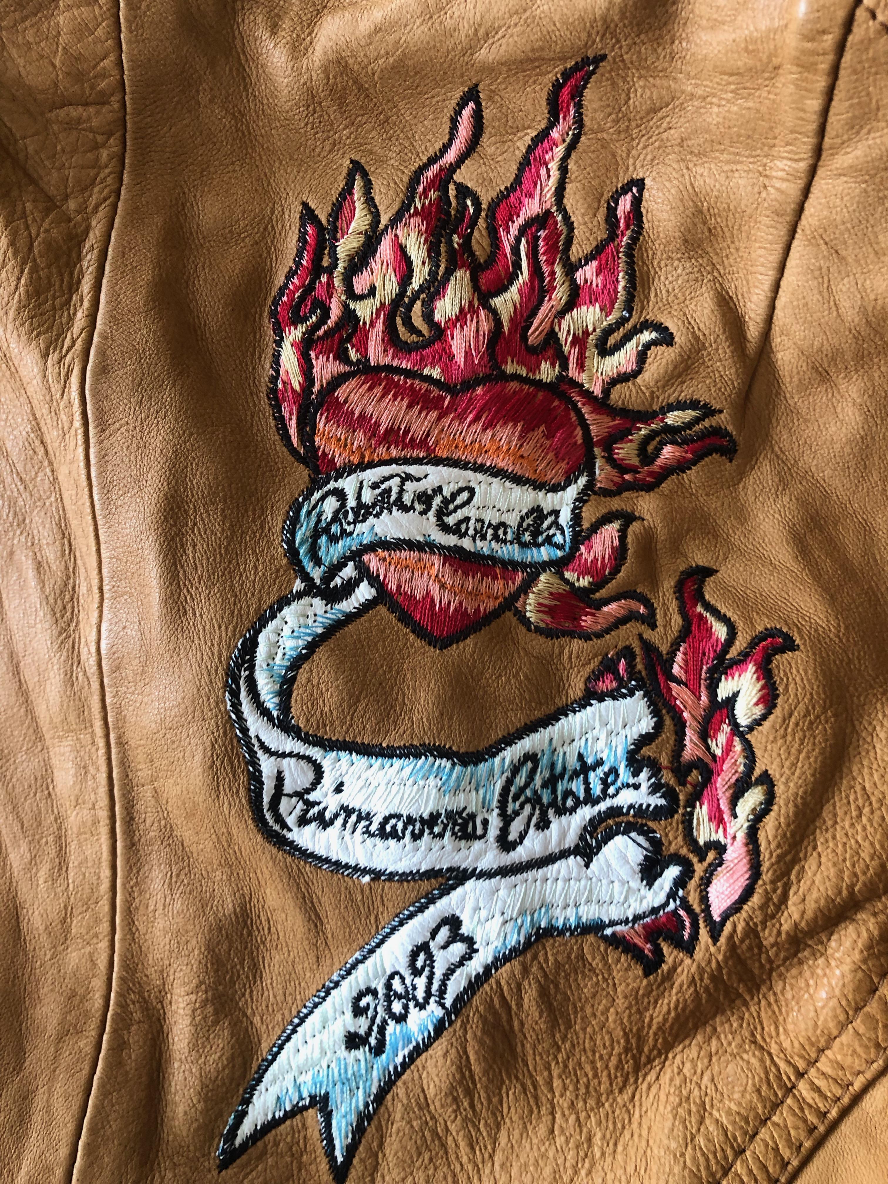 Roberto Cavalli Collectable Leather Jacket with Tattoo Embroidery 
Please use the zoom feature to see all the great details.
From 2003, this is much less distressed than many of these from this era, but it is intended to look old.
No size tag, size