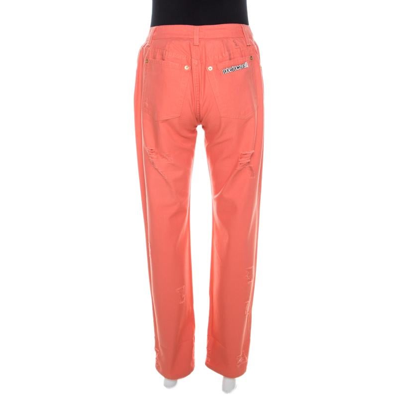 These coral pink distressed jeans from Roberto Cavalli are both comfortable and stylish! They are made of 100% cotton and feature front button fastening, belt loop closures and a crystal embellished logo on the back pocket. You can wear it for your