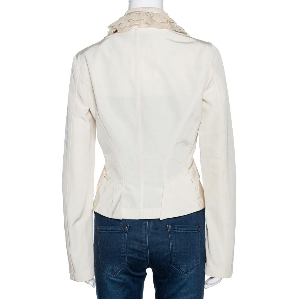 Roberto Cavalli jacket is an elegant way to layer your dresses and separates. Flaunting a cream hue, this cotton jacket features a lovely silhouette with long sleeves, a notched collar, and ruffled trims on the front. Styled with a buttoned closure,