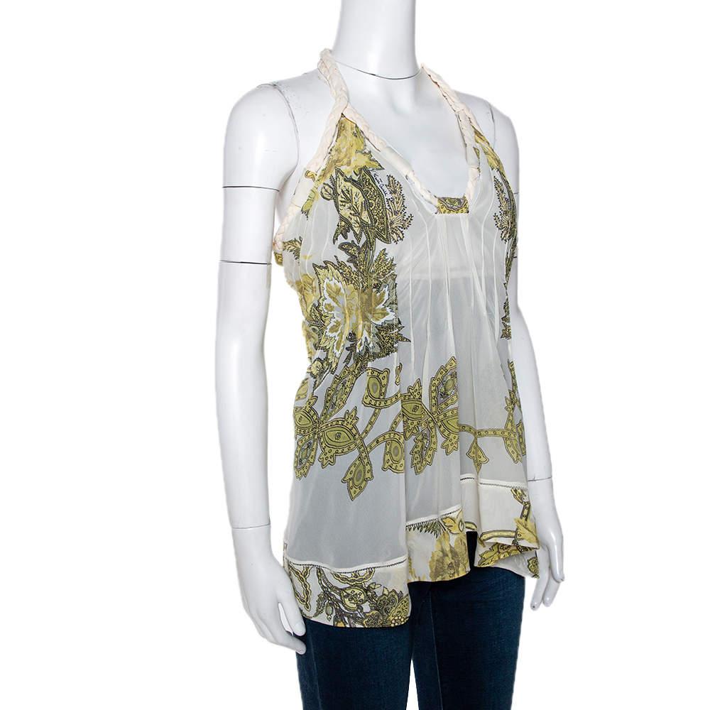This cream top from Roberto Cavalli is here to make you look fashionably divine. Tailored beautifully, the top has a halter neck, buttons at the back and lovely prints all over. Simple and comfortable, you can wear this creation with jeans or