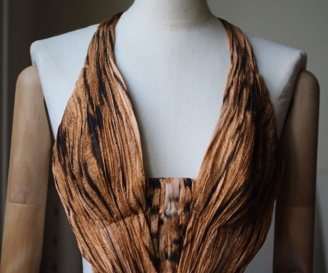 Roberto Cavalli's tiger-print gown is crafted from featherweight silk-chiffon with a plunging V-neck supported by boning. Tiger-print silk-chiffon. Concealed zip fastening along back. 100% silk; lining1: 100% silk; lining2: 71% silk, 25% polyamide,