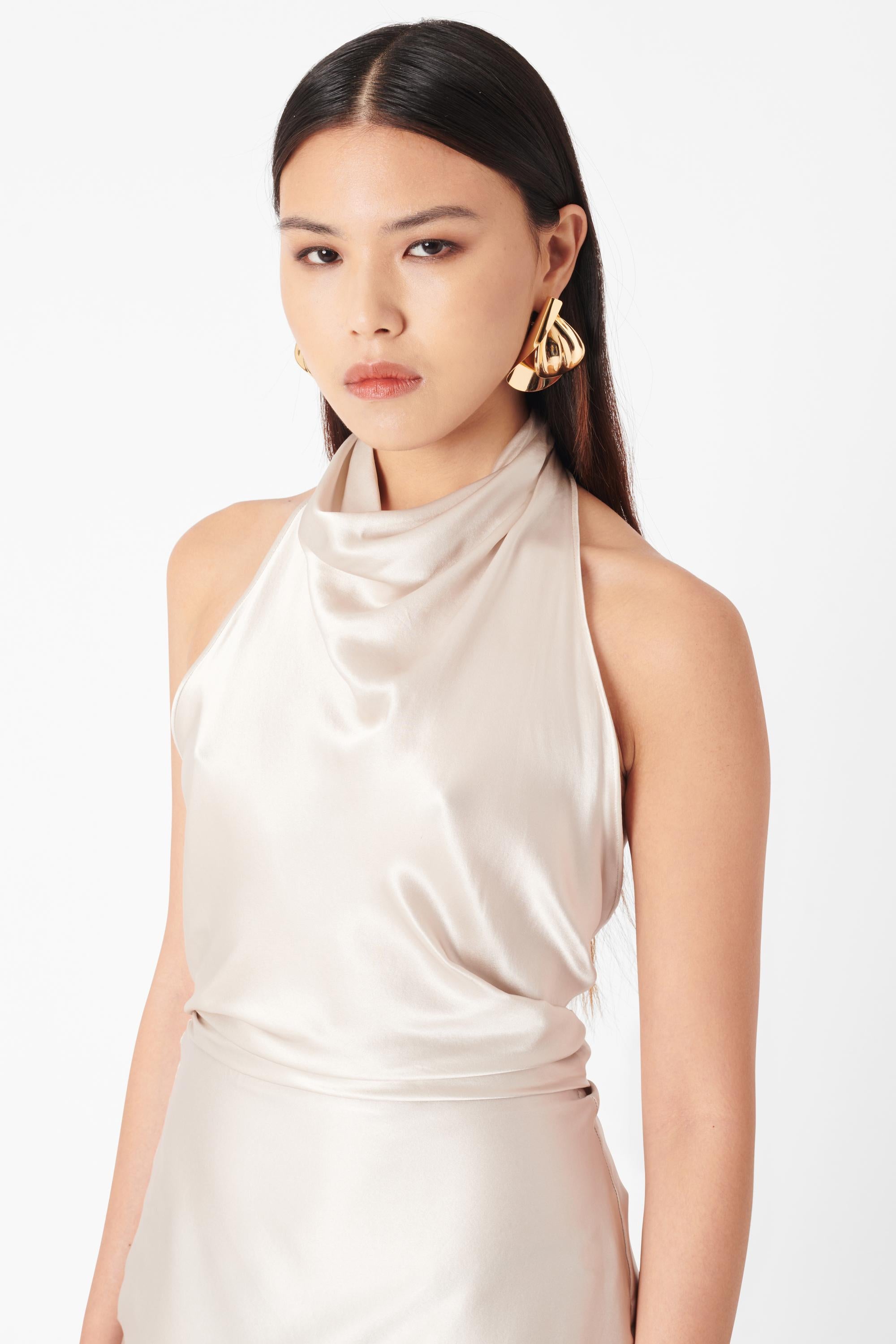 Vintage Deadstock Roberto Cavalli F/W 2007 Silk Halterneck Dress. Dress features a high halterneck, low scoop back and all over ecru silk with a gold chiffon lining. Fastened with a line of hook and eye closures at the neck and back of the dress.