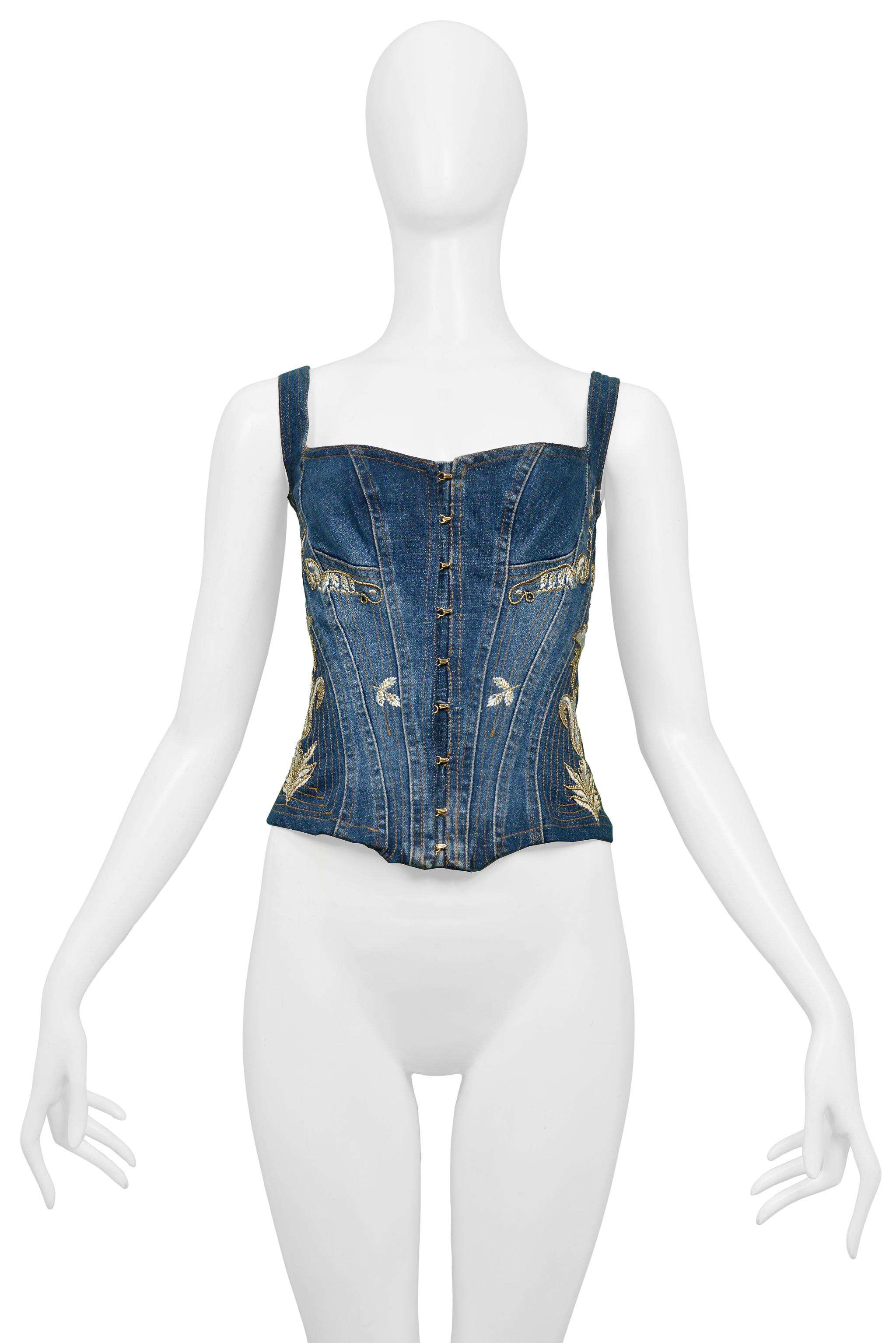 Resurrection Vintage is excited to present a vintage Roberto Cavalli denim corset top featuring gold-tone hooks and eye closures, bustier detailing at bust, gold stitching, gold embroidery, and a lace-up corset detail at the center back. 

Roberto