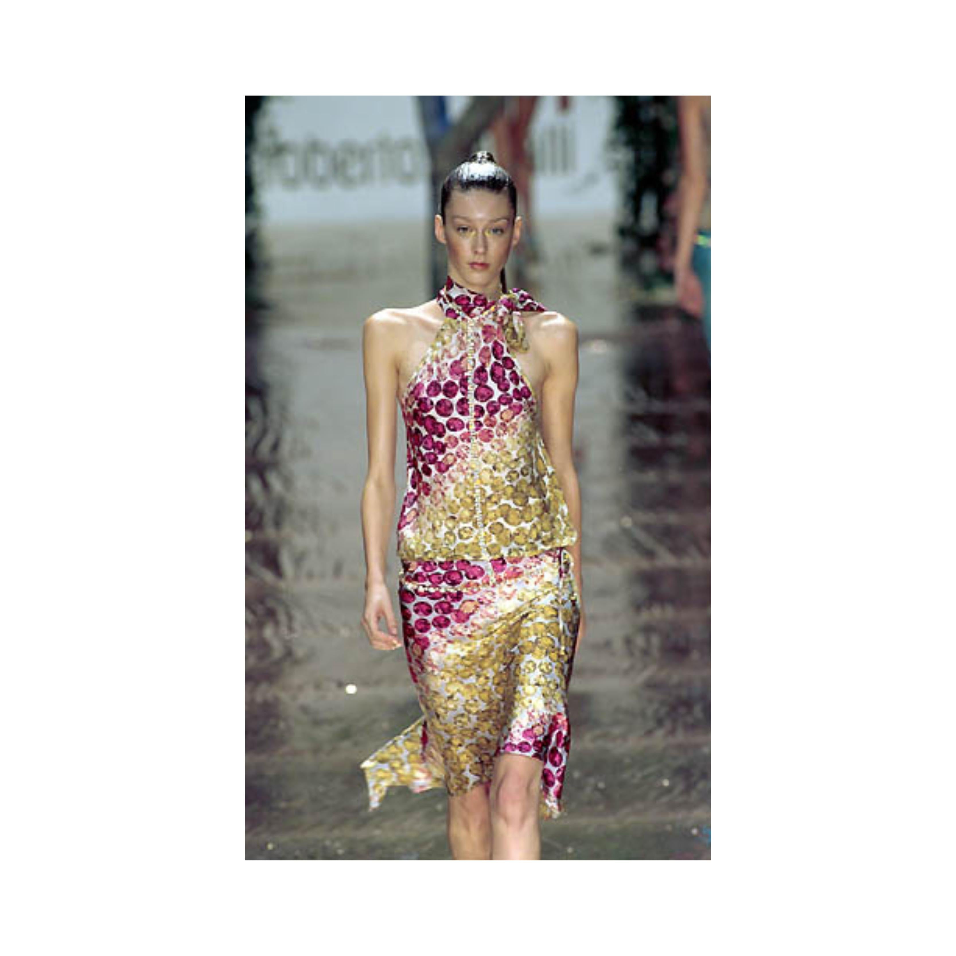 From the 2000s runway collection by Roberto Cavalli, this two-piece set features diamond jewel prints in pink and gold and is crafted from silk. The skirt has a gemstone on chain detailing and elastic on the waist. It falls gracefully on two sides,