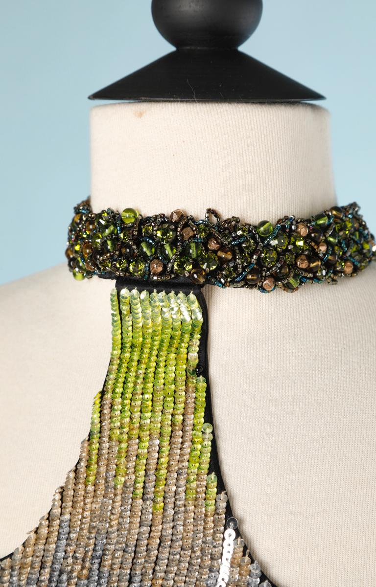 Black chiffon dress, embroidered with sequins in black, silver, grey and green shades; embroidered with green and brown pearls at the neckline.
French size 36
armpit to armpit 39cm