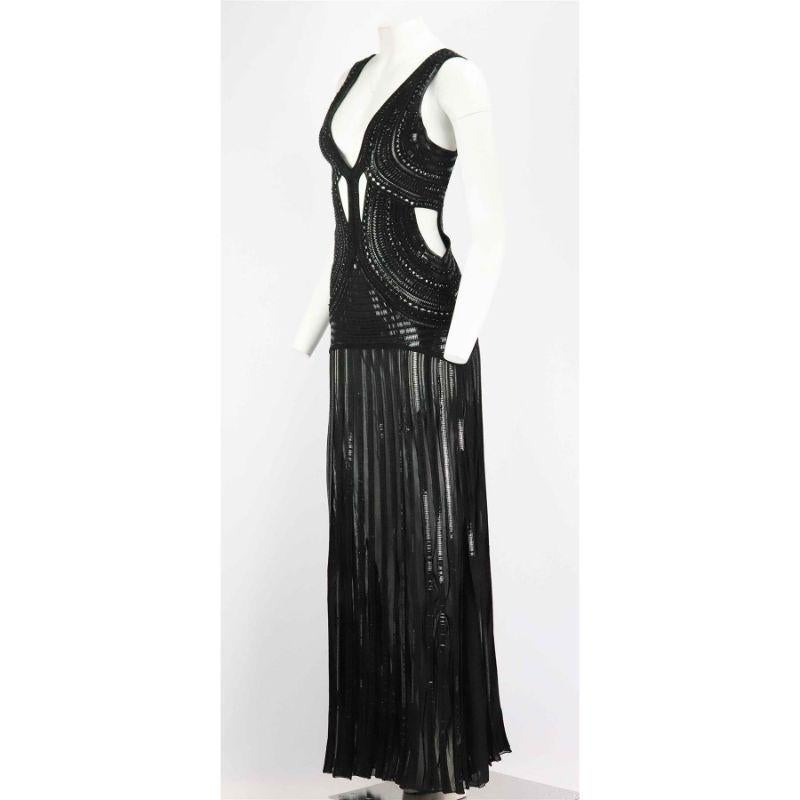 This gown by Roberto Cavalli is an eye catching piece that is intricately embellished with black embellishment detail in a cutout design with plunging neckline, pleated skirt and semi sheer stretch-knit fabric. Black viscose-blend. Slips on. 76%