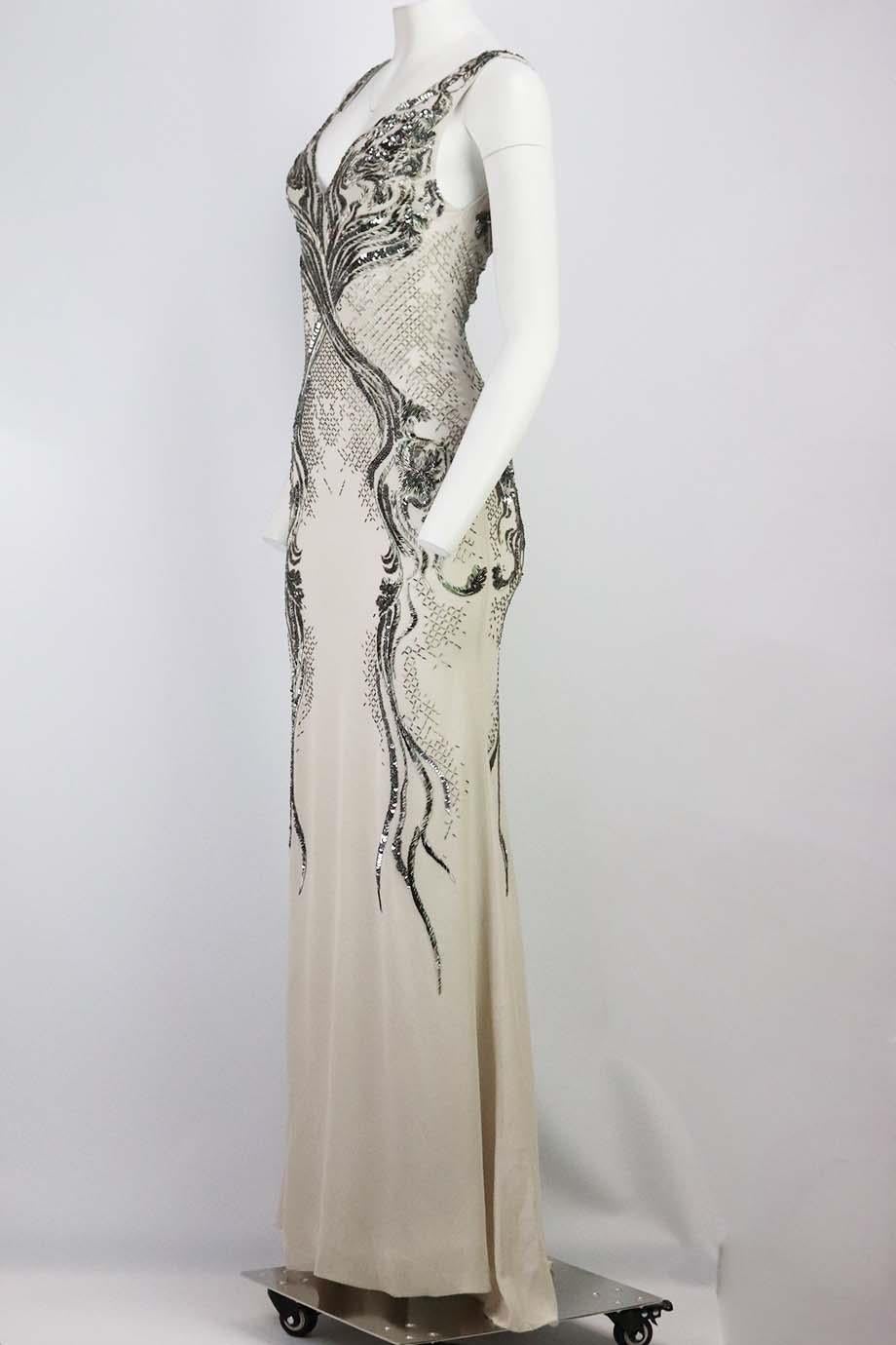This silk-georgette gown by Roberto Cavalli is ethereal and elegant, impeccably embellished with silver beads throughout, it has a slim bodice and long flowing skirt with cutout at the back. Grey silk. Zip fastening at back. 100% Silk; lining: 100%