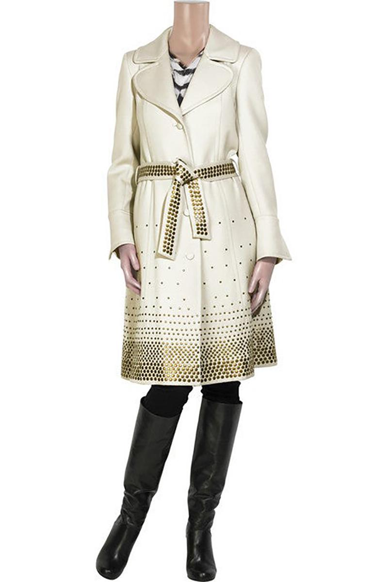 Der cremefarbene Trenchcoat aus Wolle von Roberto Cavalli erhält durch brünierte Metallnieten eine harte Note.
Der Mantel hat einen Gürtel zum Selbstbinden in der Taille, ein übergroßes Revers, geschlitzte Ärmel, einen Knopfverschluss vorne,