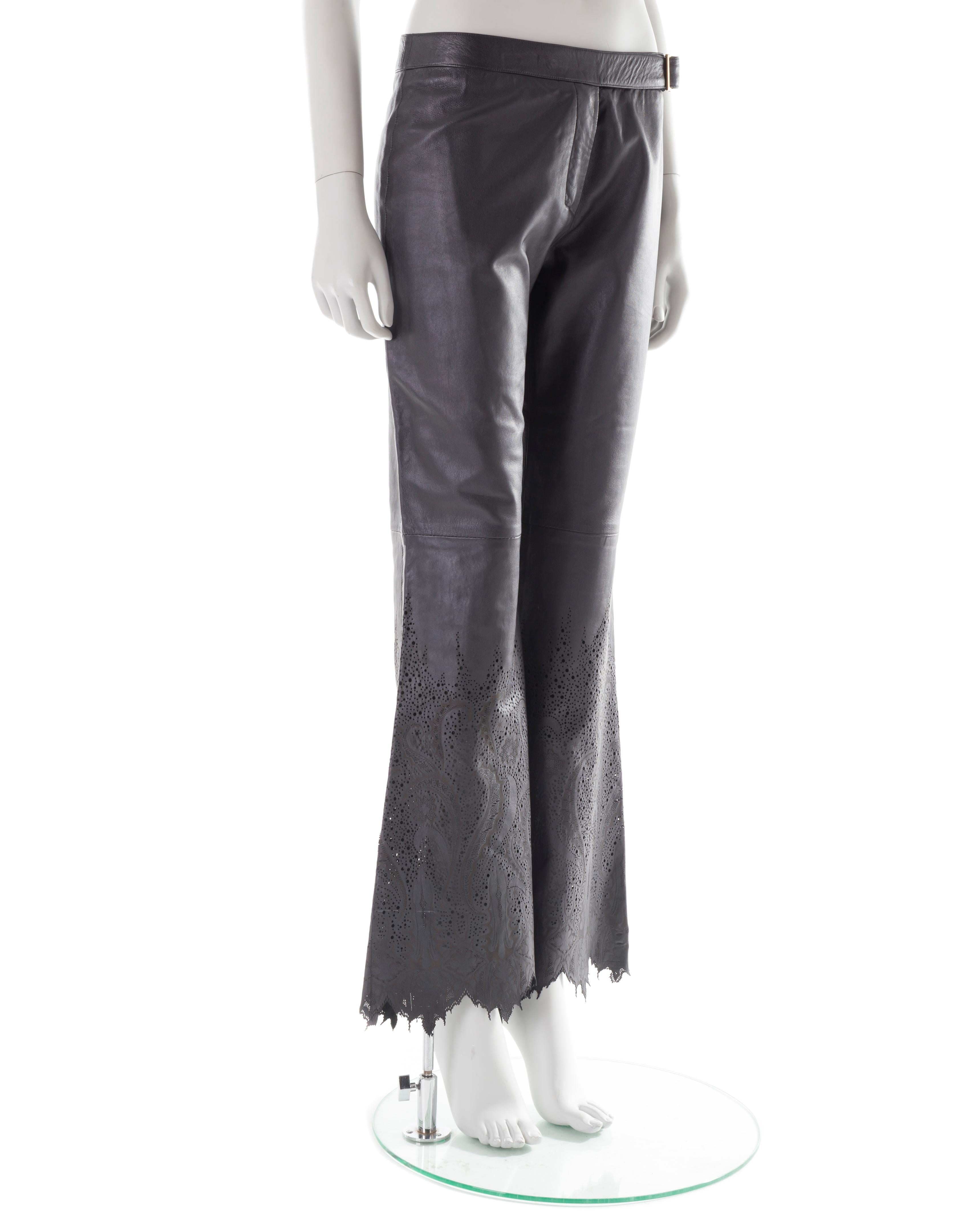 - Black soft lambskin leather pants
- Front side gold belt
- Flared torn bottoms
- Perforated abstract floral print
- Size M