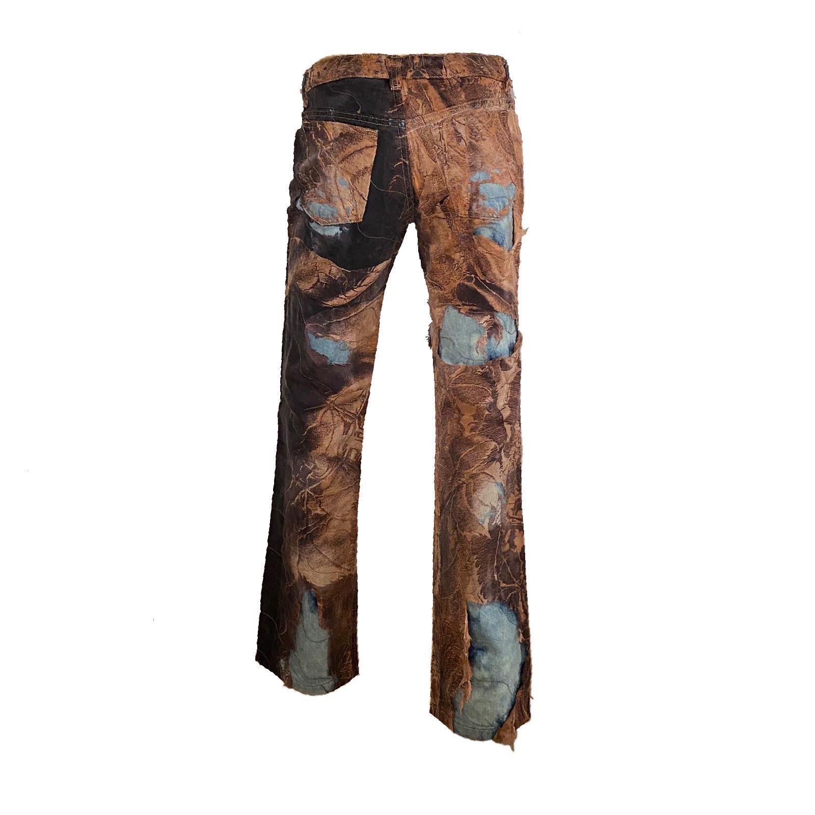 Roberto Cavalli Acid Wash Denim Pants with Distressed Outerlayer featuring a brown tapestry print from the Fall/Winter 2001 collection.

100% Cotton

Size S 
Waistline: 77 cm/ 30,3 inch
Outseam: 103 cm/ 40,5 inch
Inseam: 80.5 cm/ 31,7 inch
Rise: