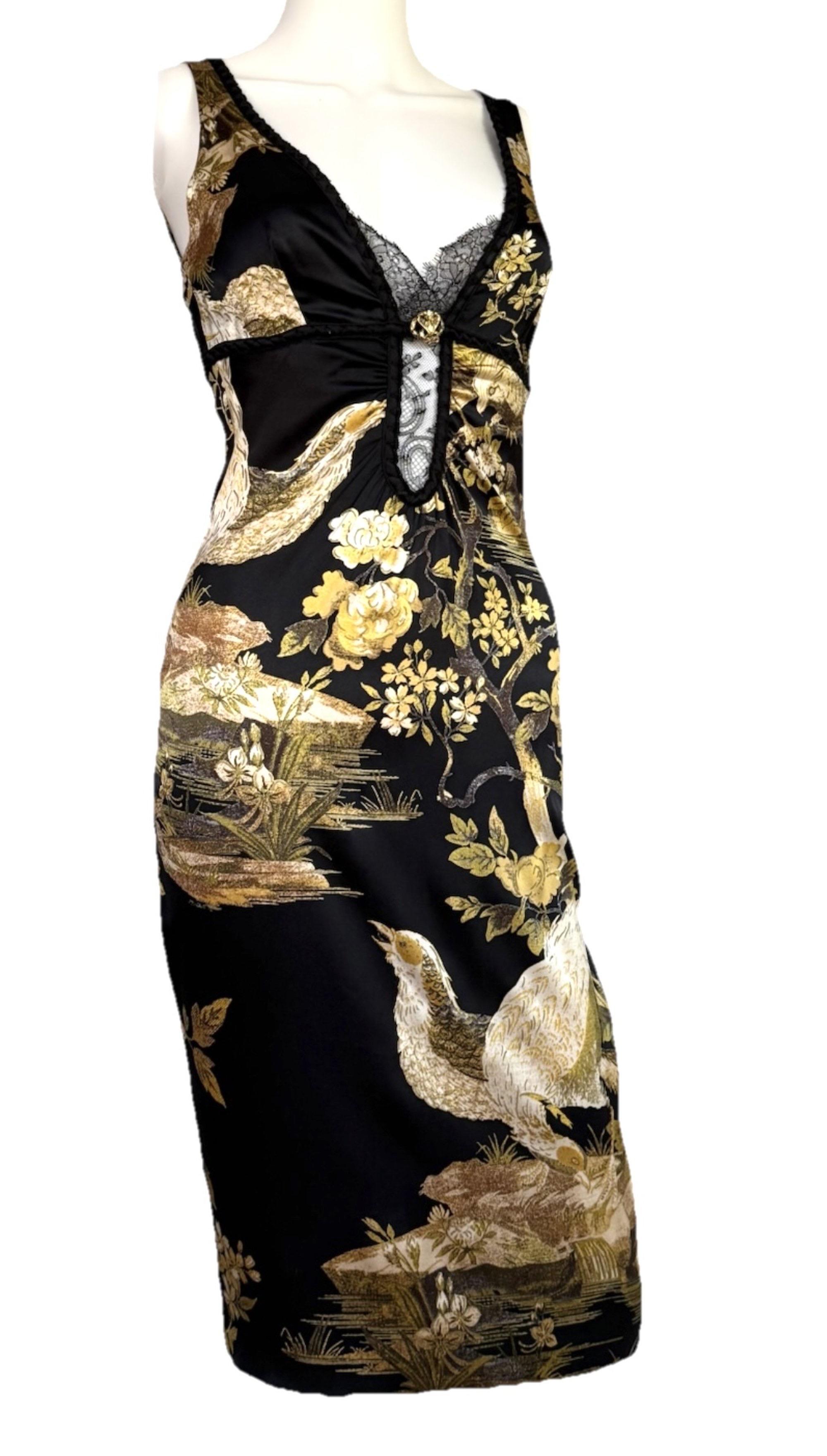 Roberto Cavalli Fall/Winter 2006 midi dress in lightweight stretch silk, featuring a black-and-gold leaf floral motif interwoven with pheasant accents. A plunging neckline is framed in sheer black lace and finished with a gold crystal–embellished