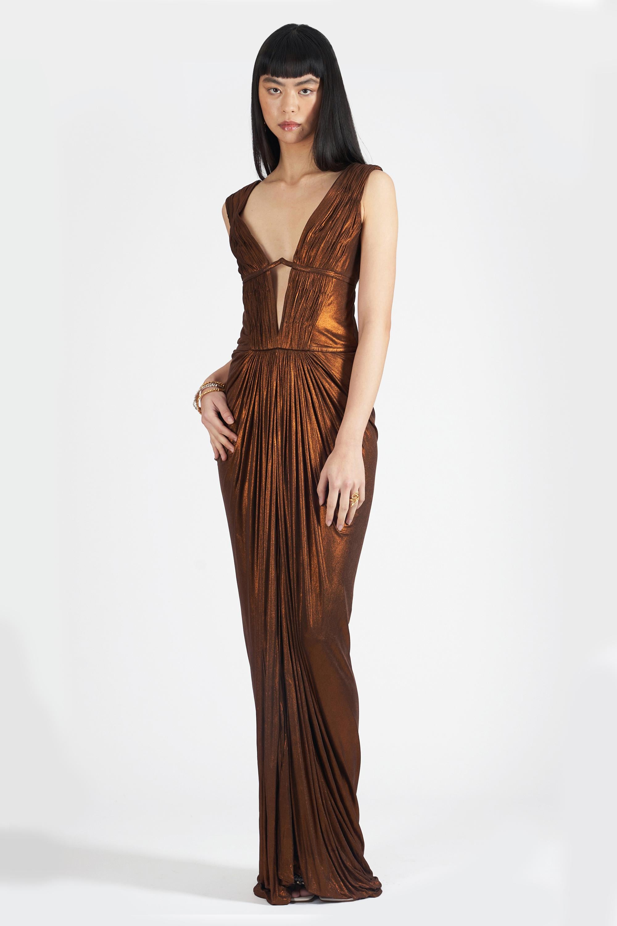 We are excited to present this 2007 Roberto Cavalli Fall Winter metallic gown. Features low cut neck, cut out detail, ruching detail, low back, zip closure and maxi length with tags. In great vintage condition, a few minor discolouration marks to