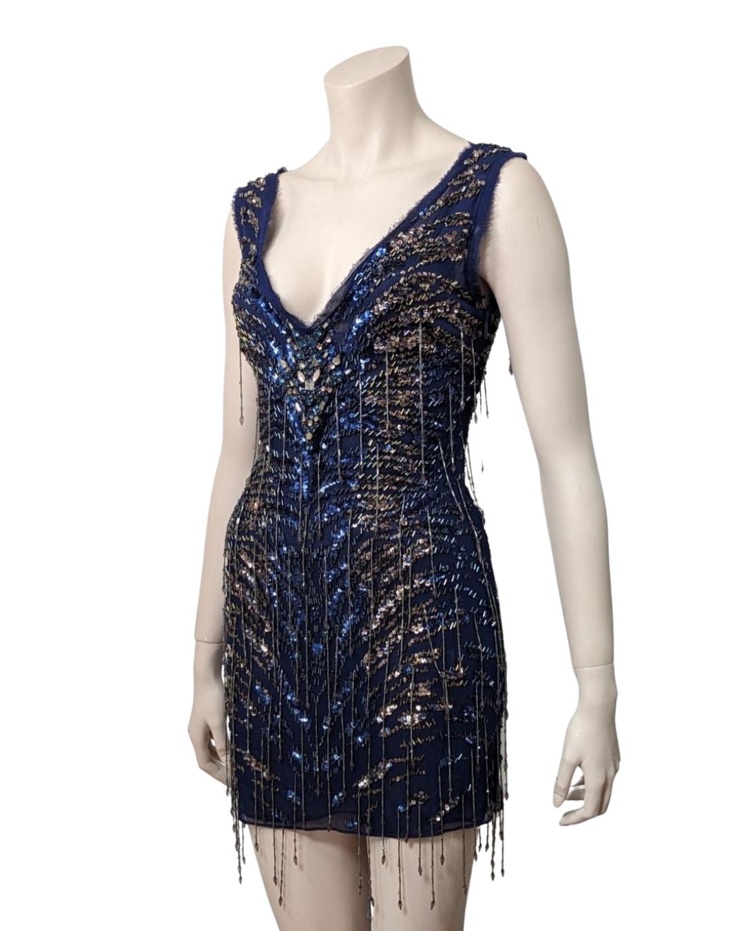 All over beaded silk mini dress. Circa 2000s. Impressive work o this dress. 

· Zip on the side
· V neckline back and bottom
. Two layers of silk fabric
 

Fits : S, M TAGS : 170 92a

Flat measurements : 

Breast : 45 cm
Waist : 39 cm
Hips : 43