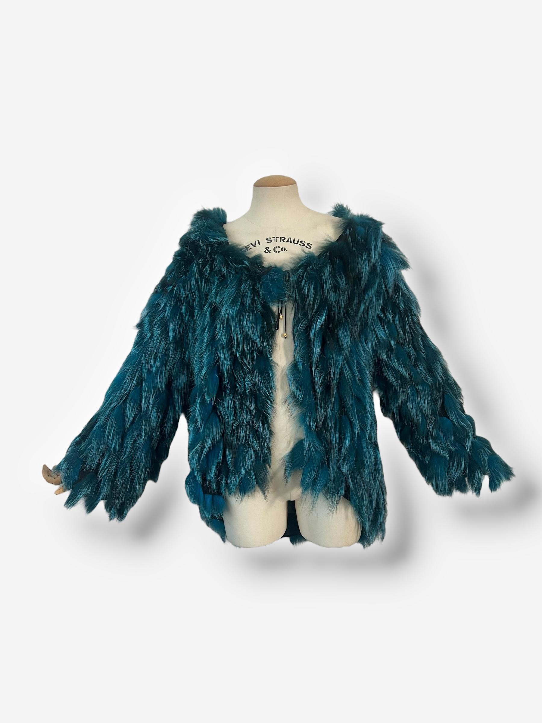 
Luxurious genuine fox fur coat from Roberto Cavalli’s Fall/Winter 2000 collection, originally showcased on the runway in yellow but produced in various striking hues, including this deep teal. This statement piece features Cavalli’s signature wild,