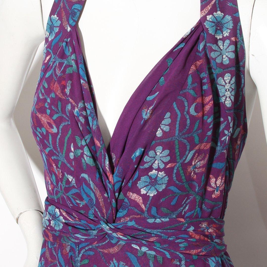Floral print gown by Roberto Cavalli
Circa 2008 
Purple dress
Multicolor floral pattern 
V-neck 
Sleeveless
Knotted tie waist 
Horsehair ruffle trim underlayer 
Zip, snap and hook and eye side/back closure 
Made in Italy 
Condition: Excellent,