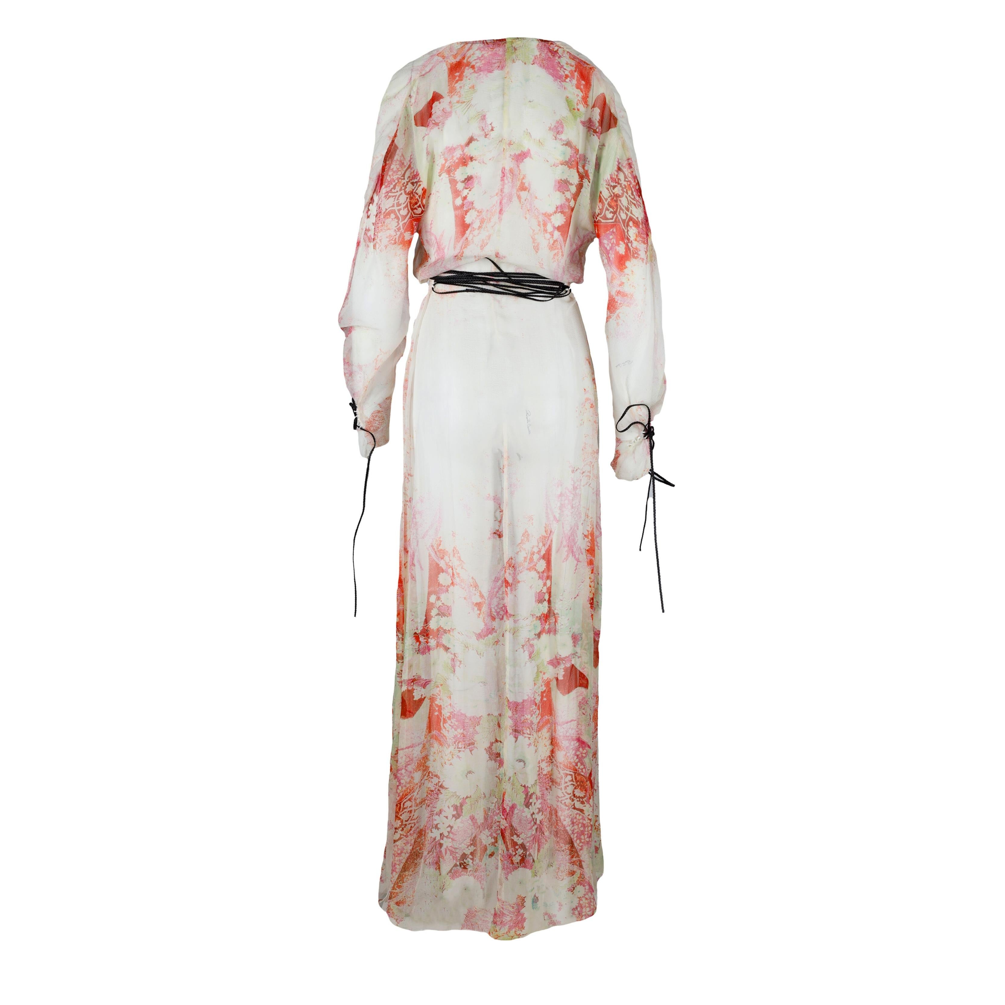 This Roberto Cavalli dress features a luxurious silk material in a multicolor floral print for a refined and elegant look. Cinched with a stylish braided leather rope, the dress gracefully drapes to the hemline with slits and panels, creating a