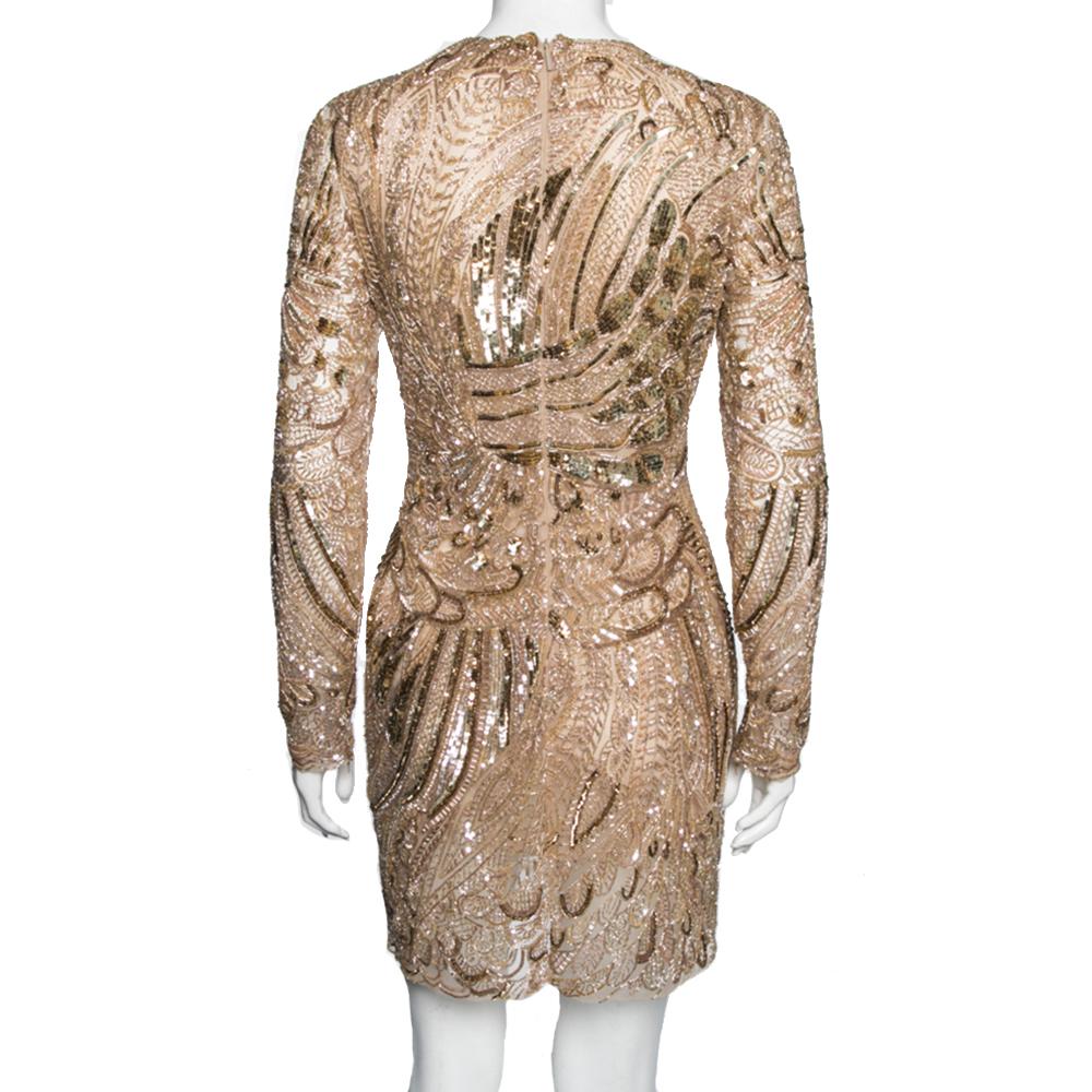 With its party-dress aesthetic and subtle glamour, this dress from Roberto Cavalli is going to make heads turn at any event! It is designed using gold tulle fabric, accentuated with intricate embellishments. It displays a well-fitted silhouette,
