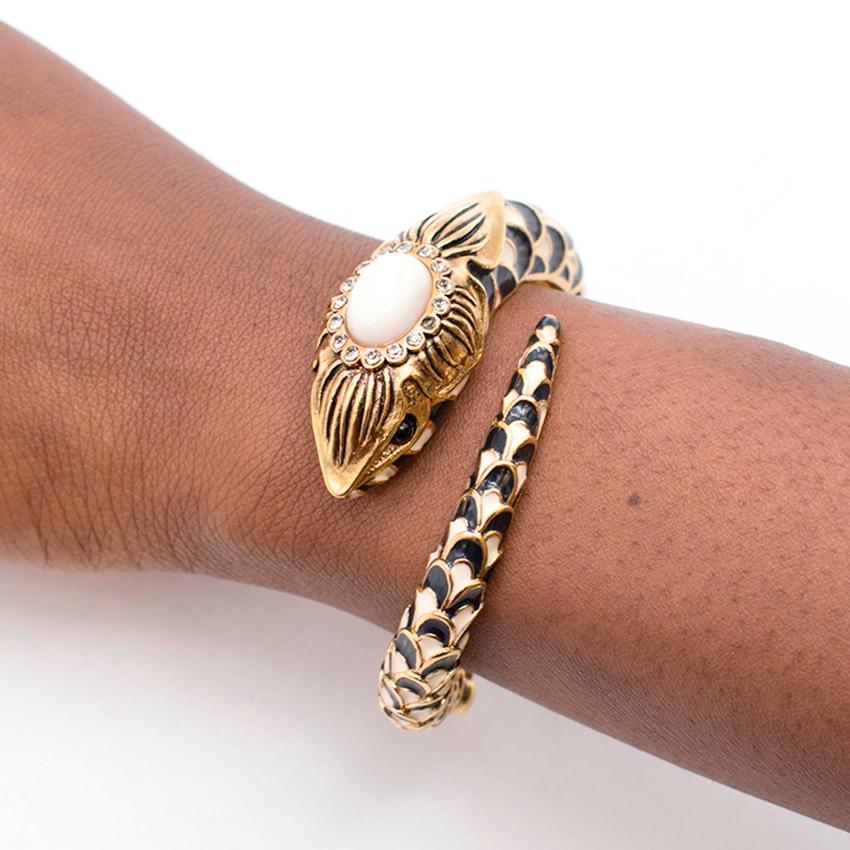 Roberto Cavalli gold snake bangle bracelet

Featuring:
-snake motif
-rhinestone 
-hinge closure
-medium weight

Please note, these items are pre-owned and may show signs of being stored even when unworn and unused. This is reflected within the