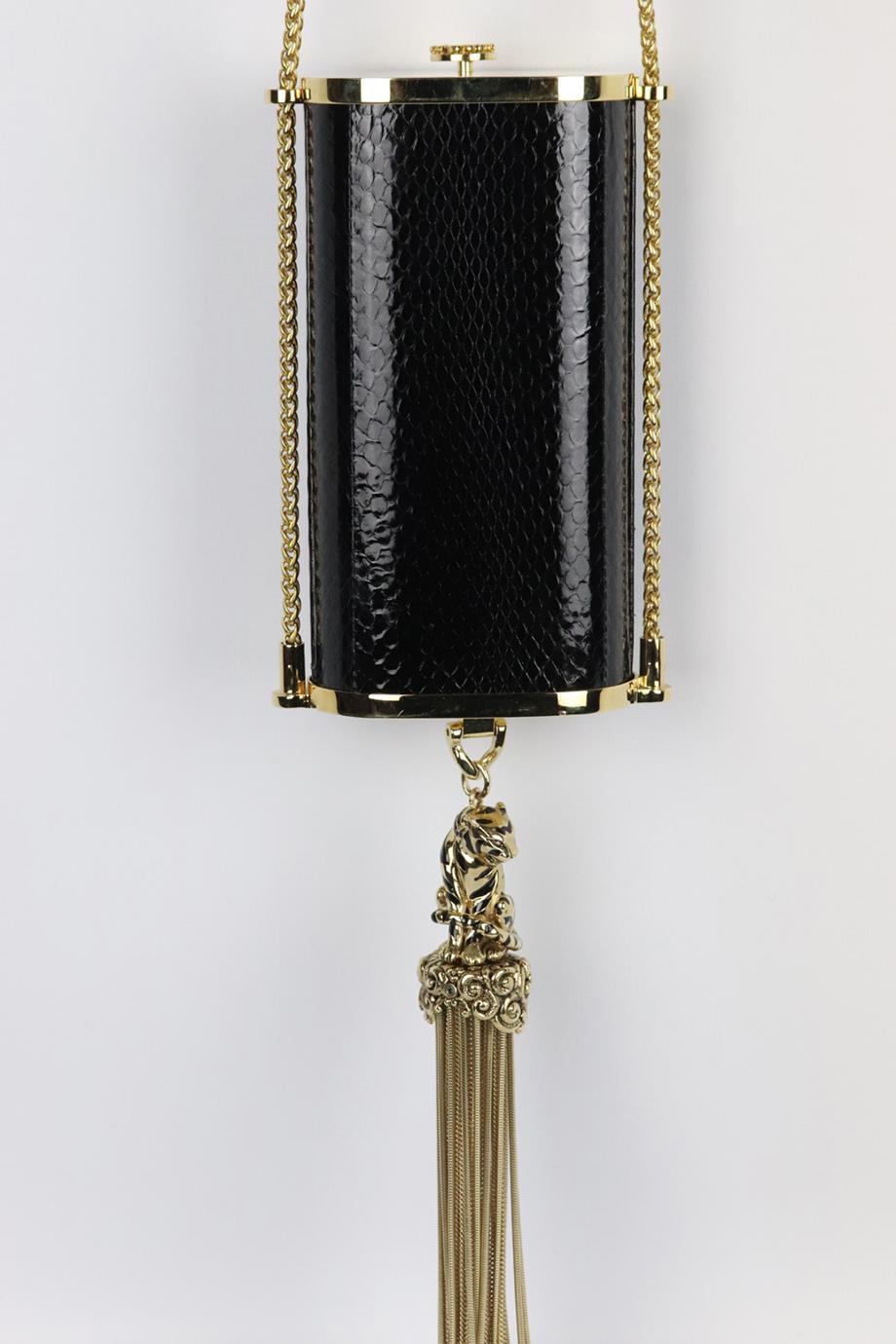 Roberto Cavalli gold tone python cylinder shoulder bag. Made from gold-tone hardware with black python in a cylinder shape and finished with a tasseled tiger. Black. Push lock fastening at top. Does not come with dustbag or box. Width: 3.5 in.