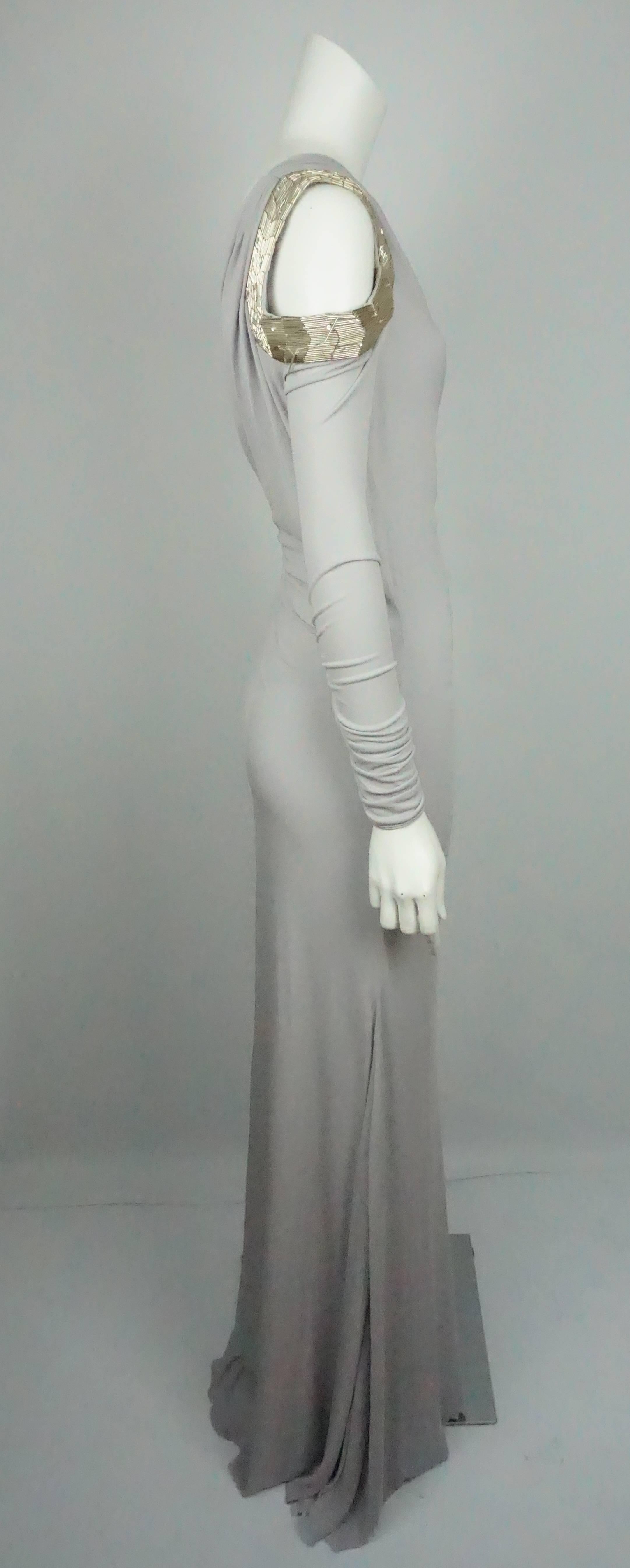 Roberto Cavalli Grey Silk Jersey One Shoulder Beaded Gown - 42  This beautiful gown is in good condition. The dress is made of a poly-blend material and is lined in silk. The dress is a one shoulder that is long sleeve and has a ruching detail on
