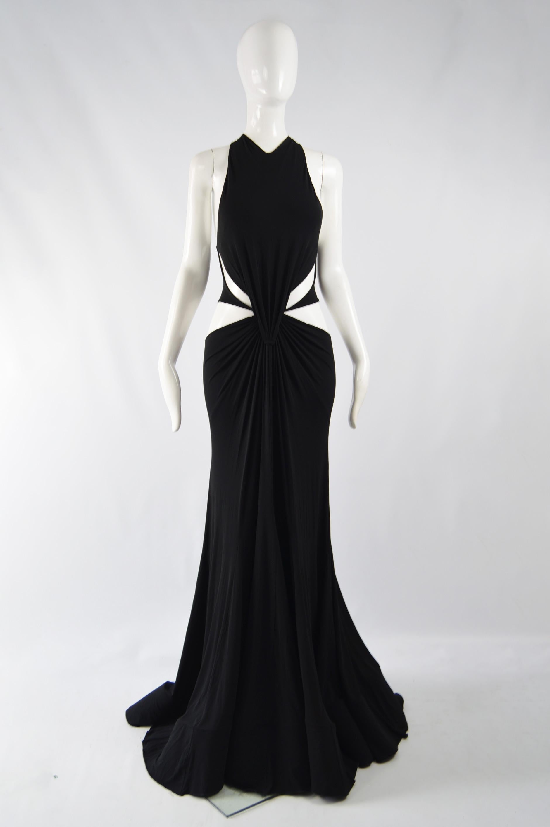 An incredible red carpet evening dress by Roberto Cavalii, the twin of this dress was worn by supermodel Karolina Kurkova at the Cannes film festival. In a black rayon knit jersey with cutouts at the side and an amazing train that has a deep