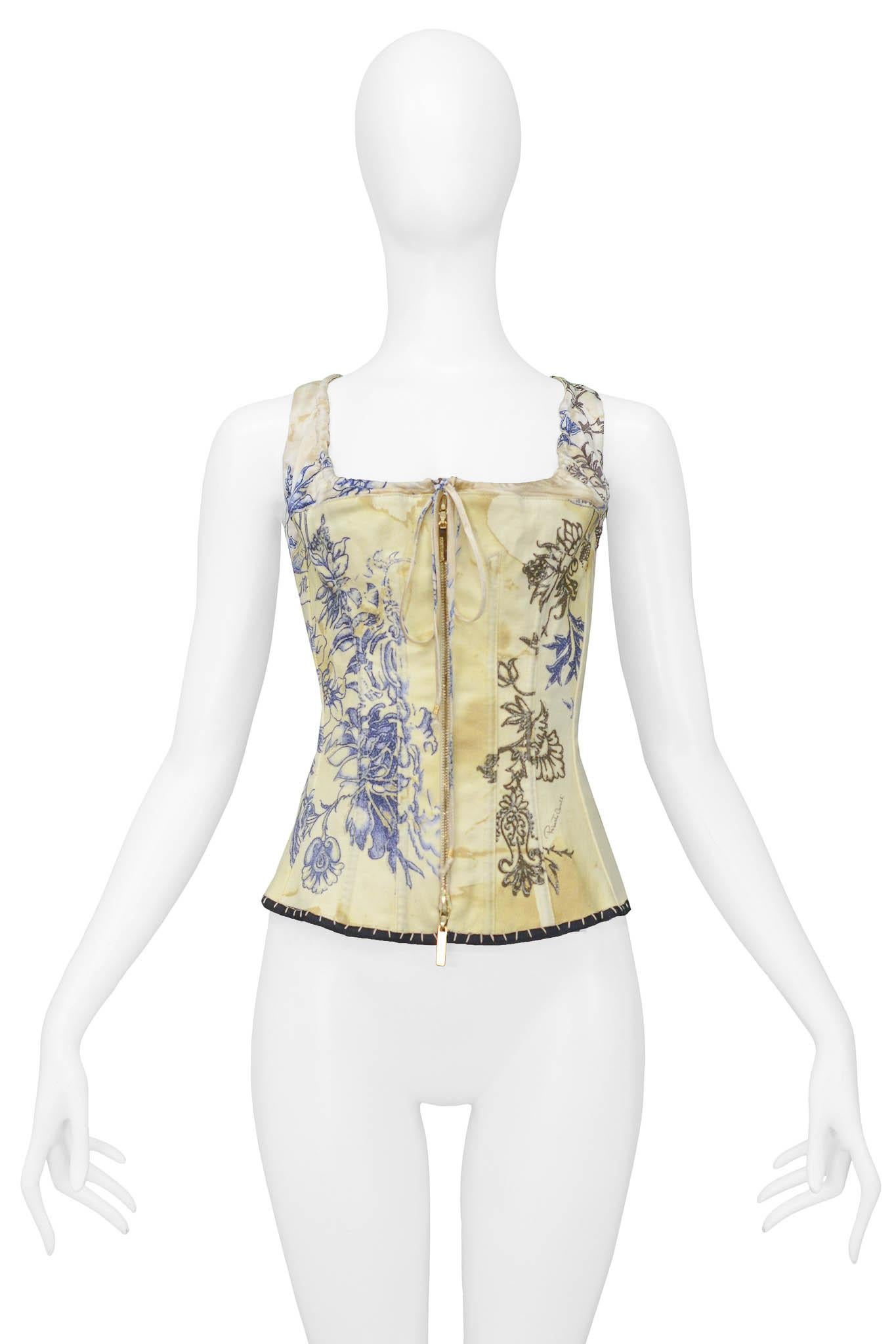 Resurrection Vintage is excited to present a vintage off-white Roberto Cavalli corset top featuring tattoo inspired print of a tiger and flowers, a two-way gold zipper down the front, a drawstring neckline, and a front made from woven cotton and a