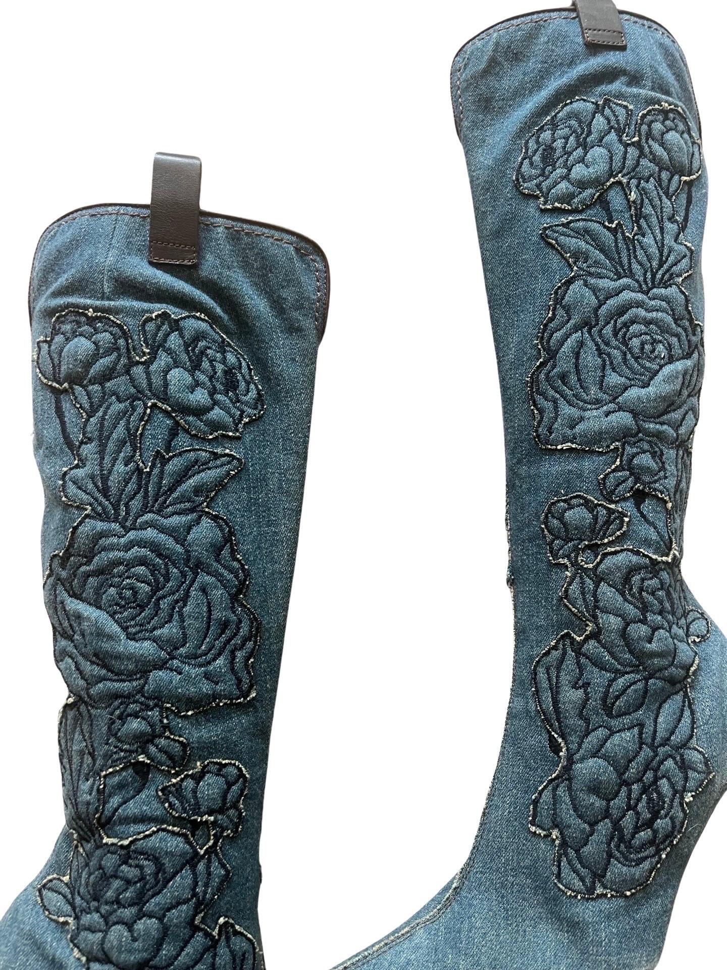 Highly coveted vintage Roberto Cavalli knee high boots in denim with floral denim appliques up the sides. Zip closure and lined in an animal print leather with a leather pull tab on the top sides. Wooden heel of 4