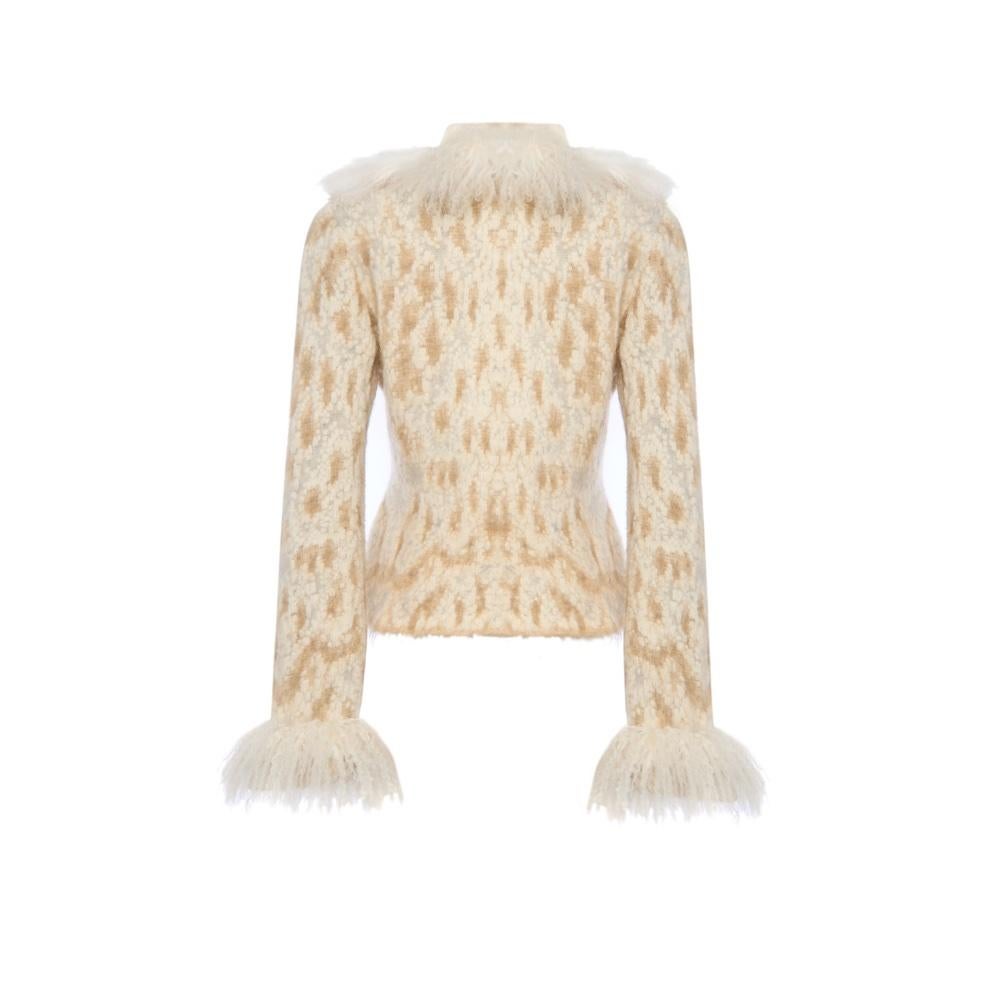 This stunning Roberto Cavalli jacket is a statement piece for any wardrobe. Featuring luxurious Mongolian fur detailing on the collar and cuffs, this jacket effortlessly blends boldness with elegance. The rich cream color and double-breasted design