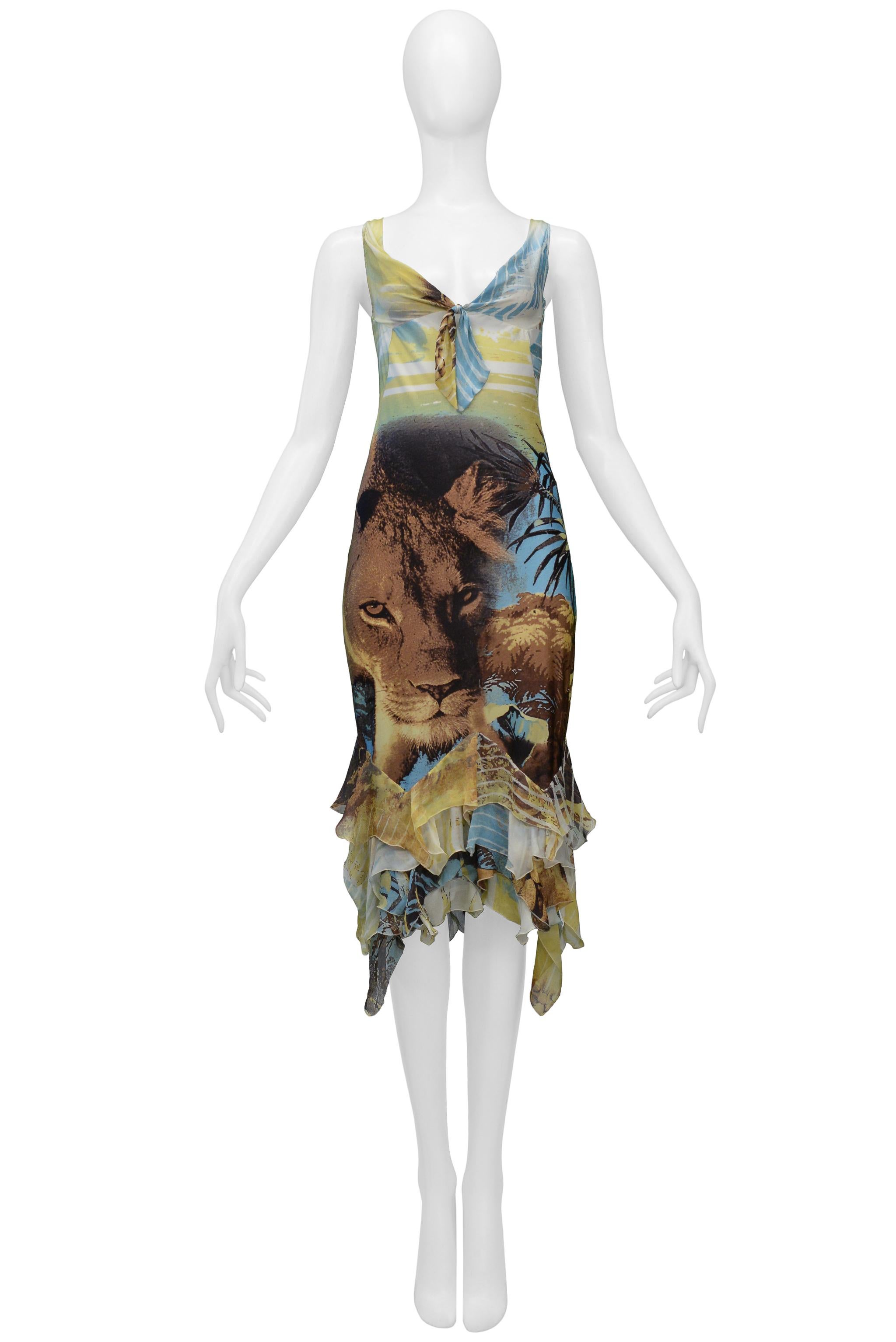 Resurrection Vintage is excited to present a vintage Roberto Cavalli blue and yellow silk and nylon dress featuring a bold lion head print, tie front, chiffon ruffles, and knee-length. 

Roberto Cavalli
Size: Medium
Silk and Nylon Jersey
Excellent