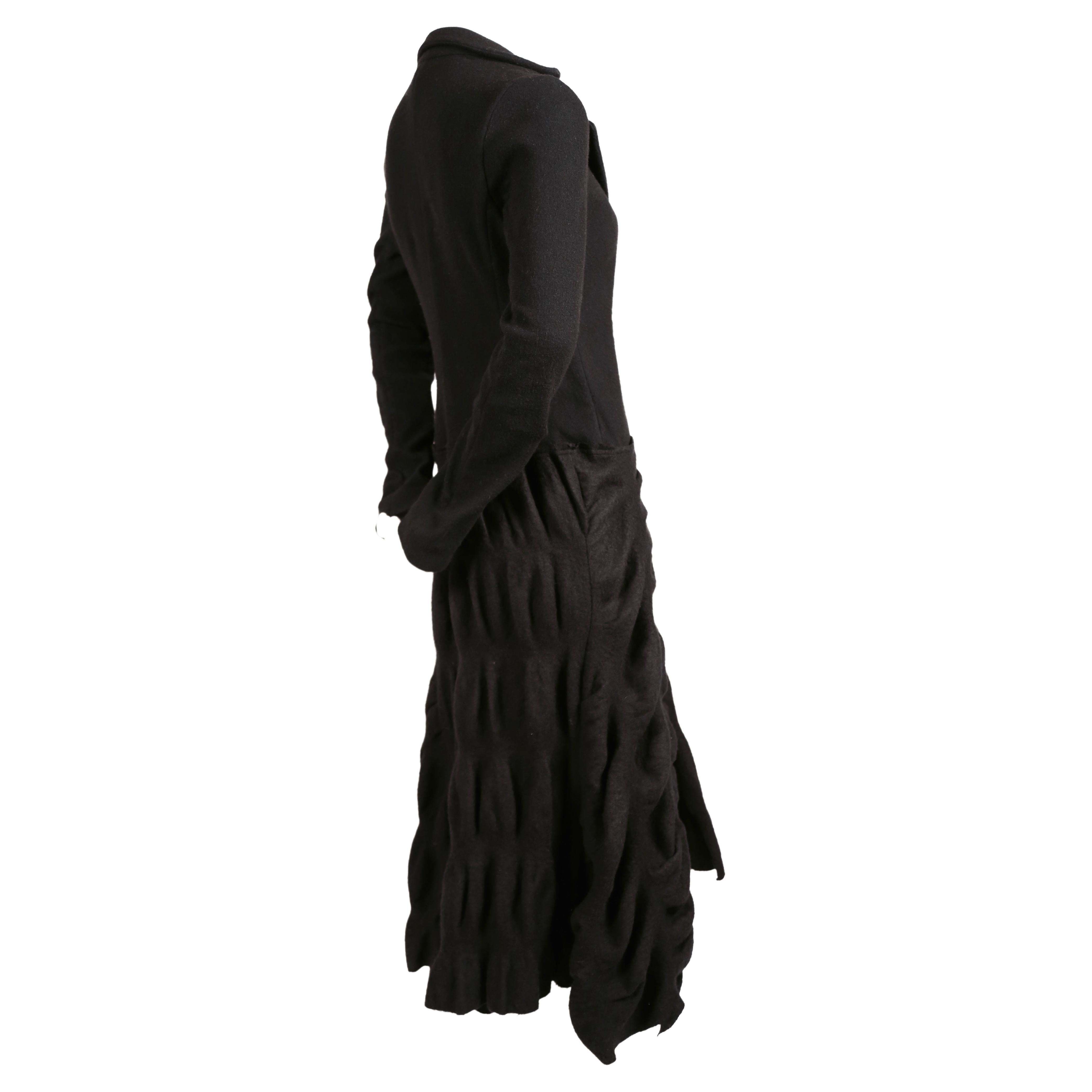 Long black coat with puckered wool fabric designed by Roberto Cavalli for Just Cavalli. Italian size 40. Approximate measurements: shoulder 15