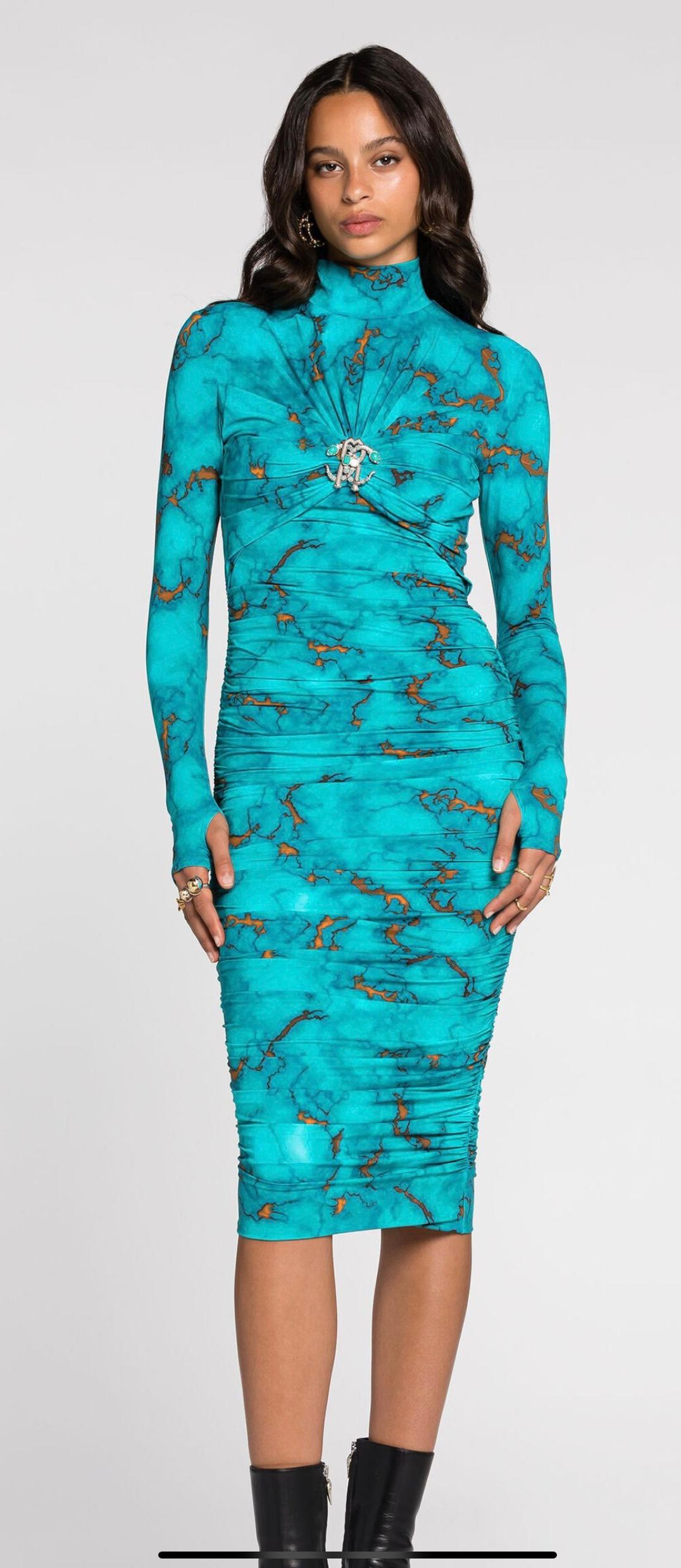 Roberto Cavalli Marble Print Turquoise Bodycon Midi Dress-Size 40 NWT - Retail $1,635 The color on the website says light blue, however it is more of a turquoise.
Cavalli's maximalist mood is showcased in this vibrant turquoise dress; it's decorated