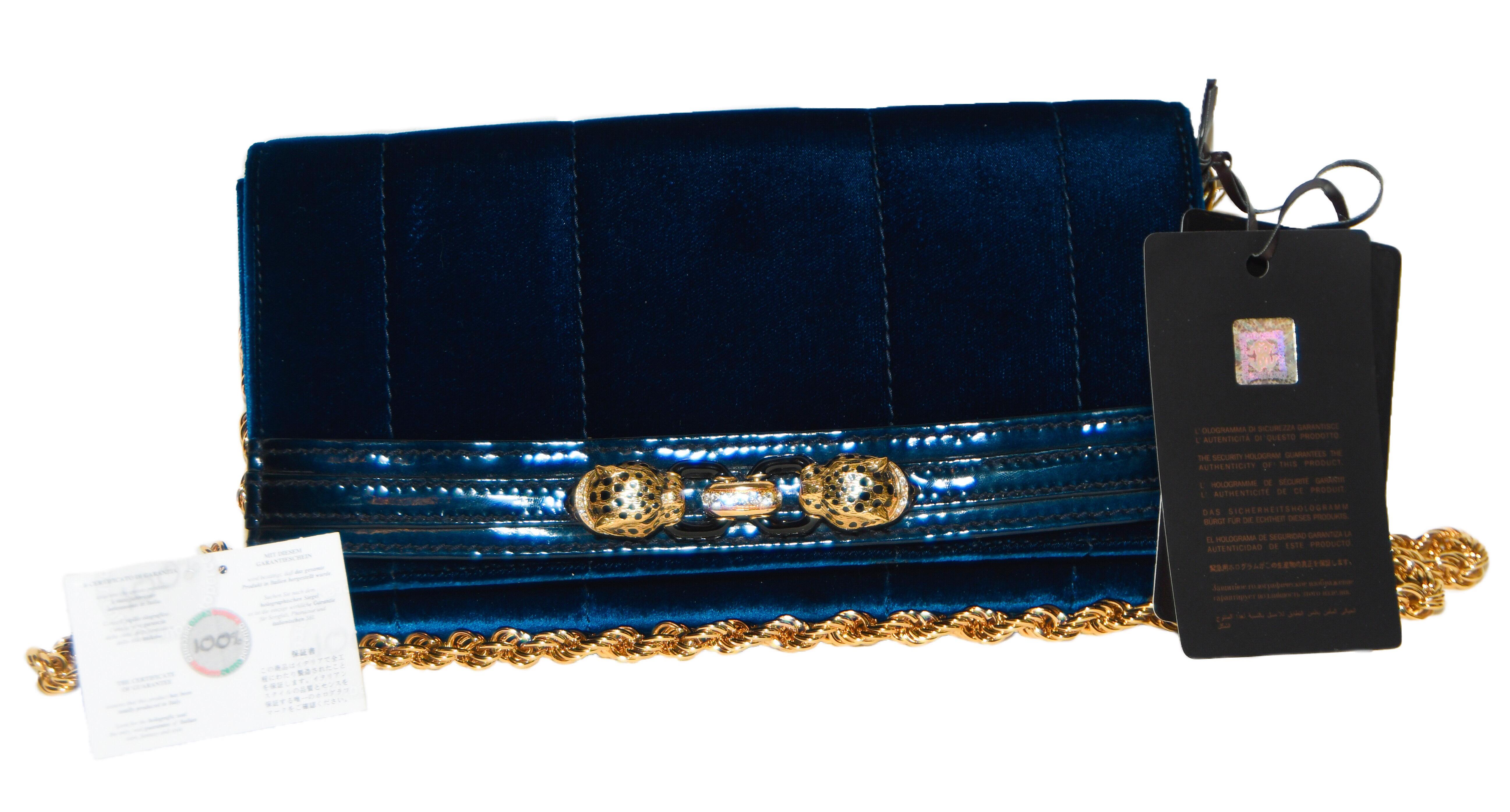 This Roberto Cavalli piece is designed to carry your daily essentials or evening belongings in ease and style. This pochette is created with a mix of fine fabrics and leathers.  Delicately layered in blue velvet and patent leather with two leopard