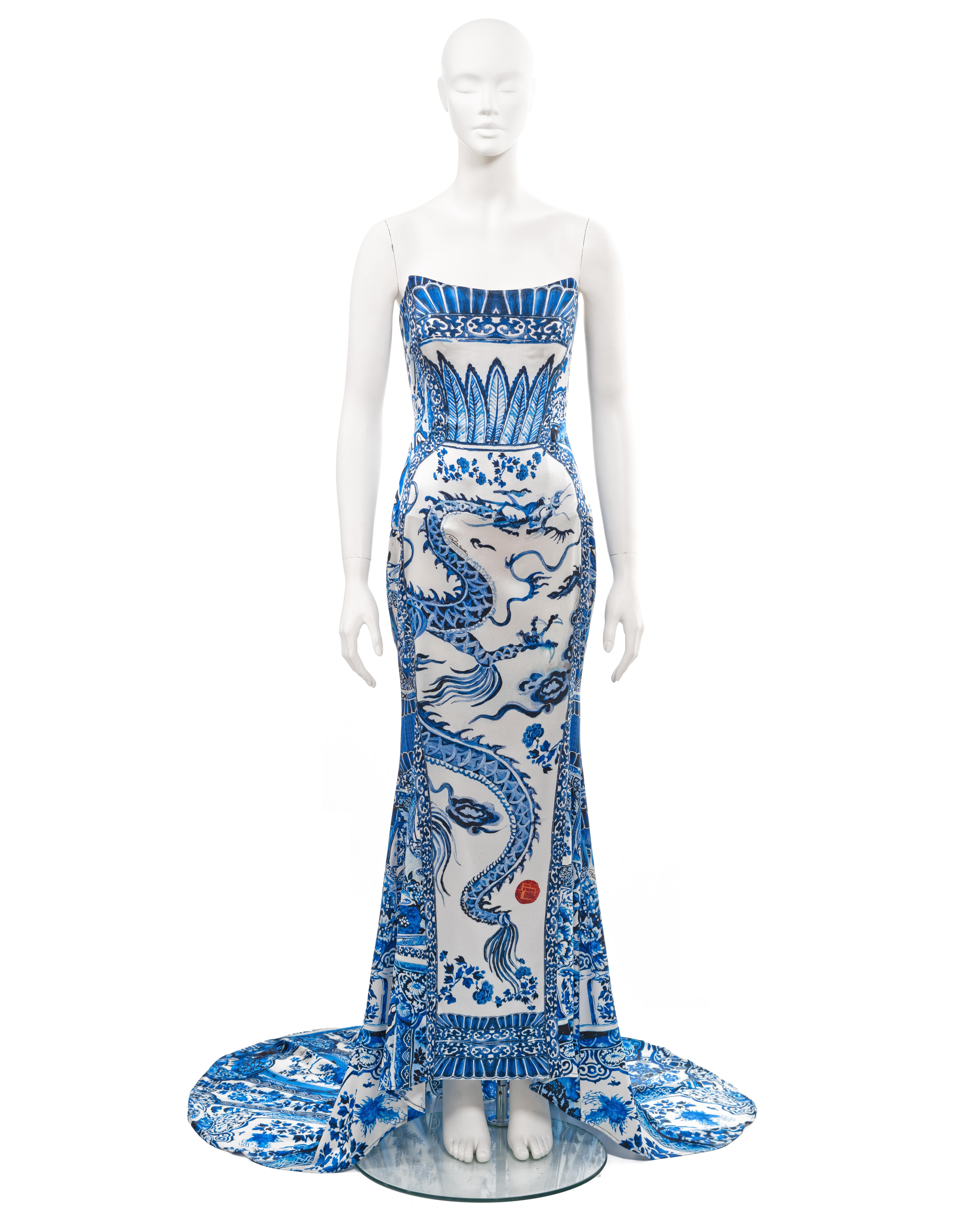 ▪ Roberto Cavalli blue and white printed silk evening dress
▪ Sold by One of a Kind Archive
▪ Fall-Winter 2005
▪ Museum Grade
▪ Constructed from silk with Ming porcelain inspired print of coiling dragons in pursuit of a red flaming pearl
▪ Strapless