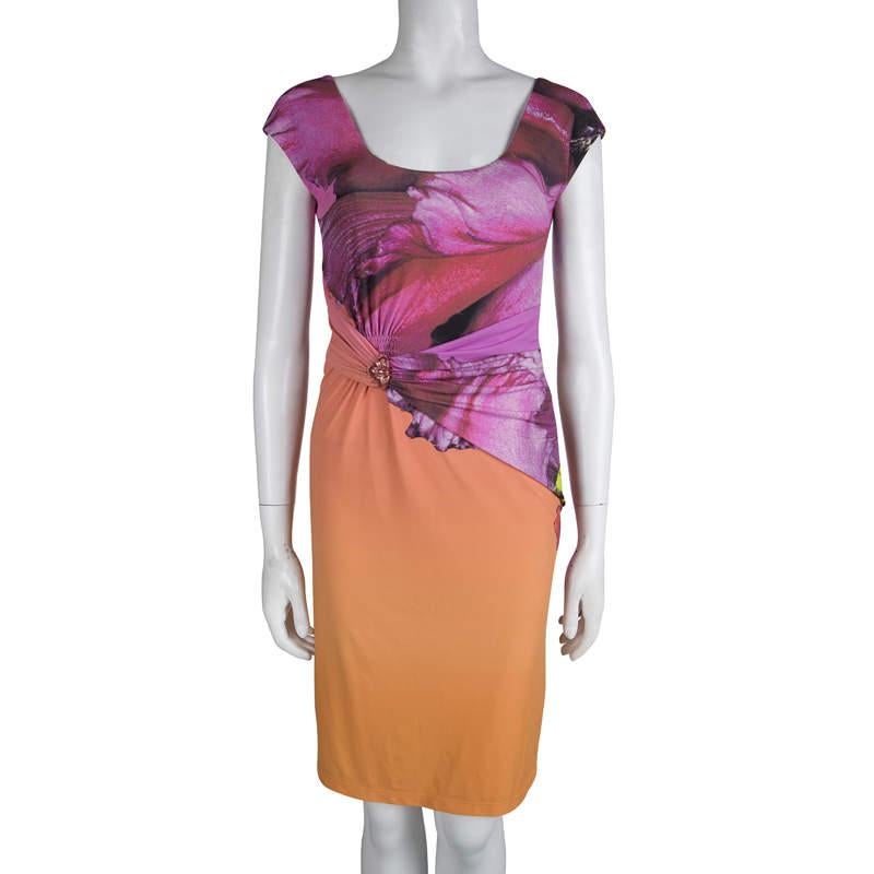 Greys and browns fade away with this multi-coloured dress from Roberto Cavalli. The wide neck - both front and back- along with cap sleeves looks casually stylish. The fitted look is enhanced by the draped material around the waist, held by a
