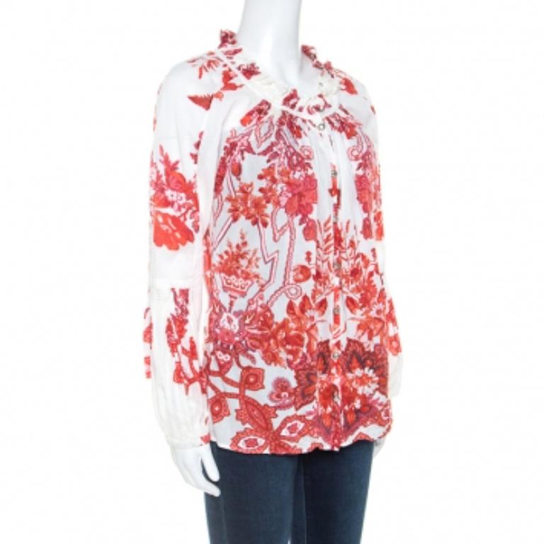 Mettez de l'ambiance et de l'atmosphère dans tous les lieux où vous vous rendrez en portant cette ravissante chemise Roberto Cavalli. Imprimé avec des fleurs,  ce haut blanc cassé est confectionné en 100 % coton. Il présente des détails ruchés au